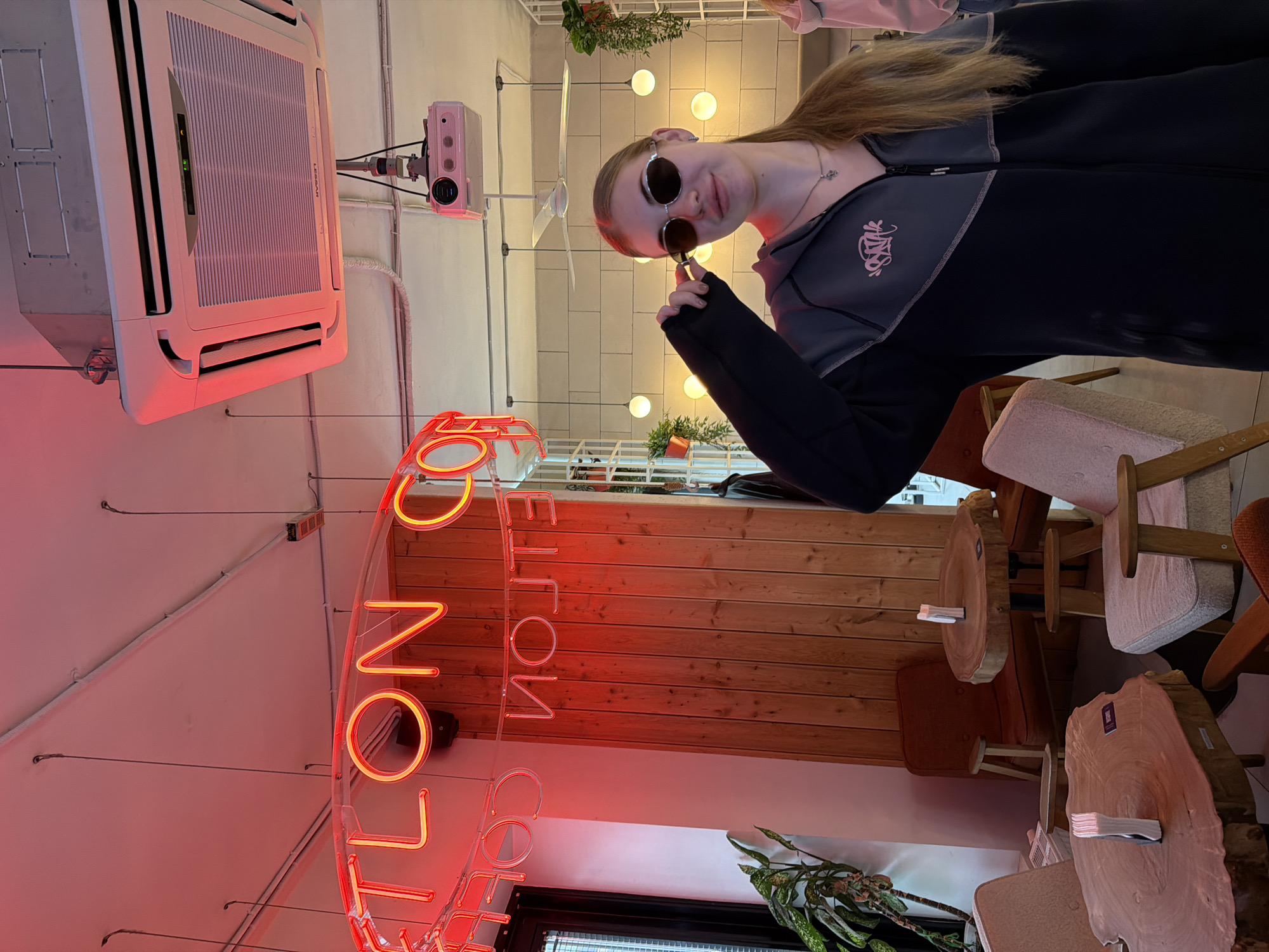 Quick pause at a Shushary cafe, sunglasses adjusted