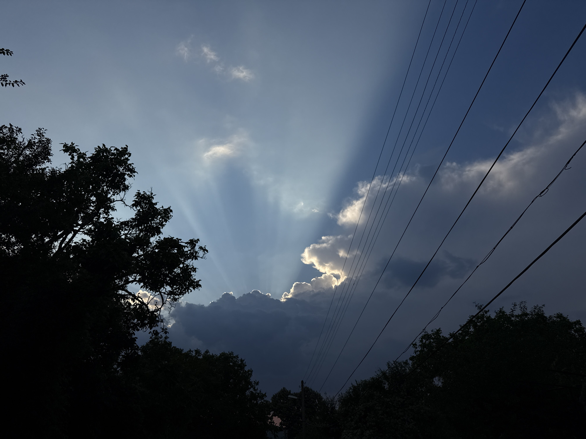 Crepuscular rays cut through storm clouds over Krushevo