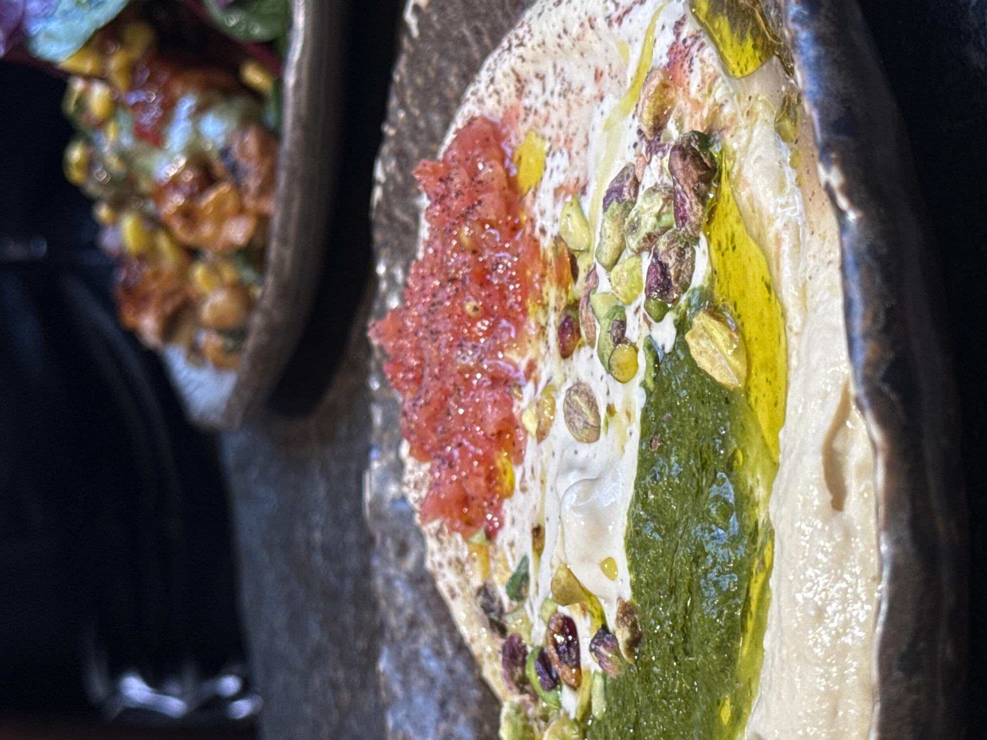 Vibrant hummus dish photographed in Barcelona dining venue