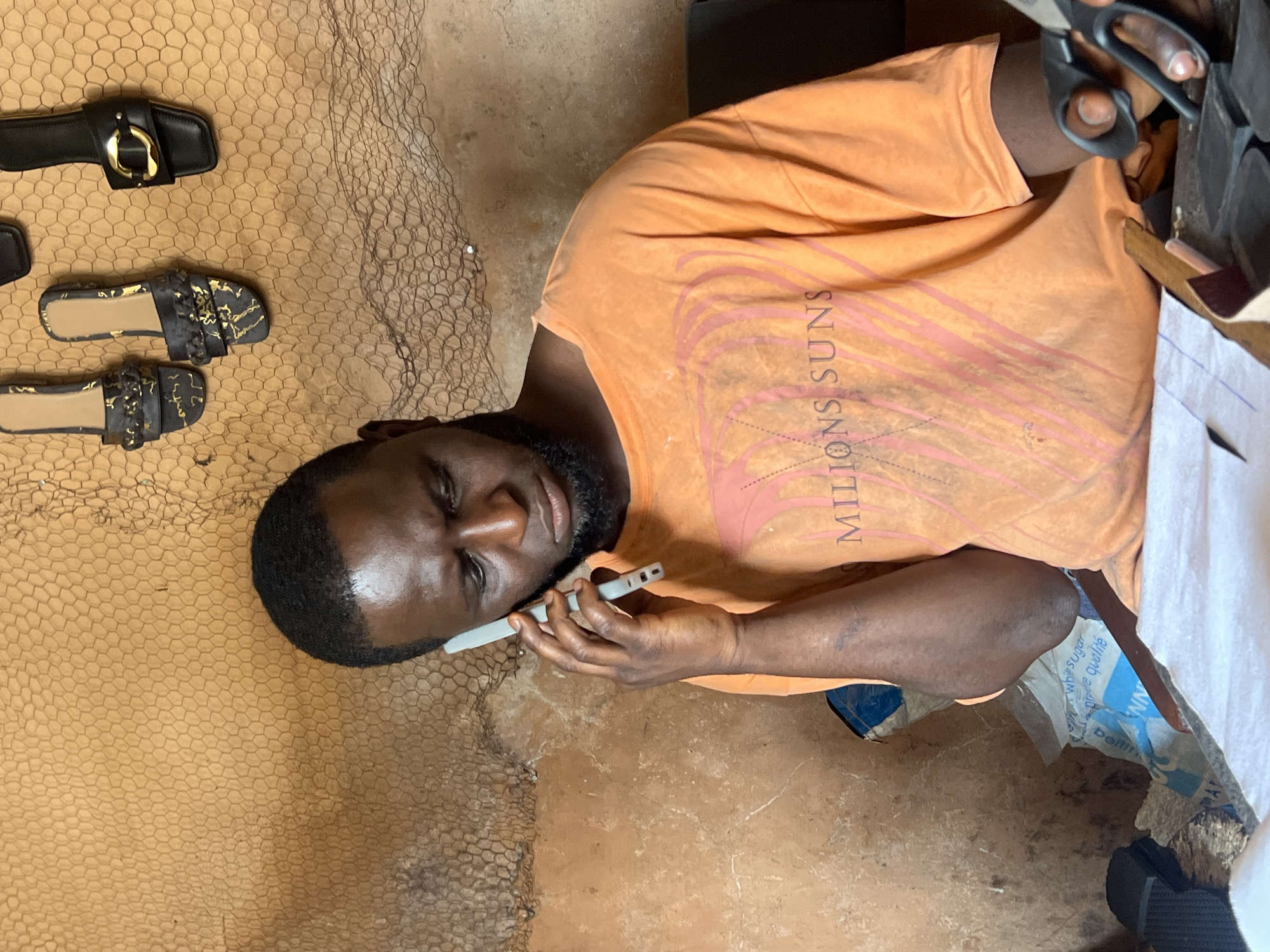 Shoemaker at work in a Jos, Nigeria workshop
