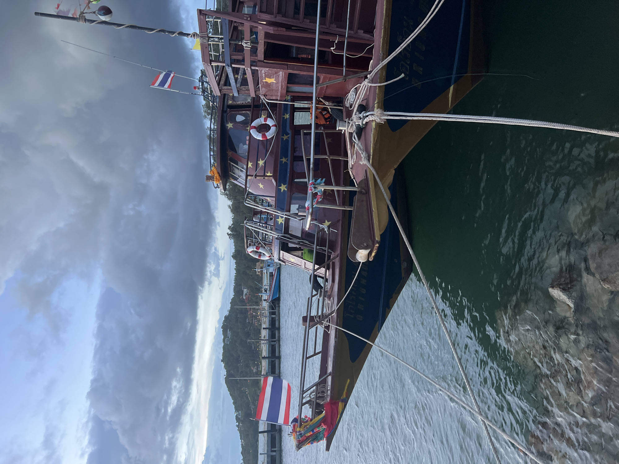 Koh Phangan harbor and surrounds, boats and construction equipment on a cloudy morning