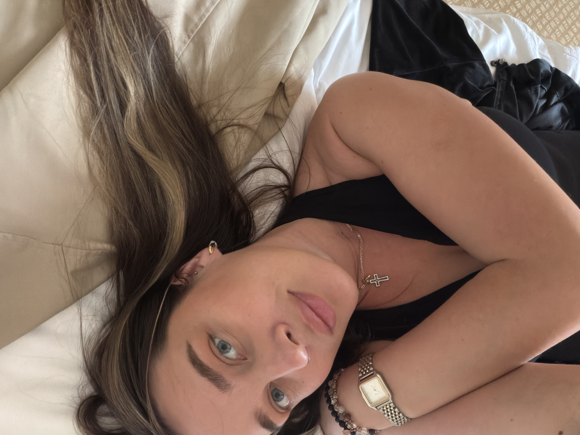 Woman resting on bed captured in elevated angle observation