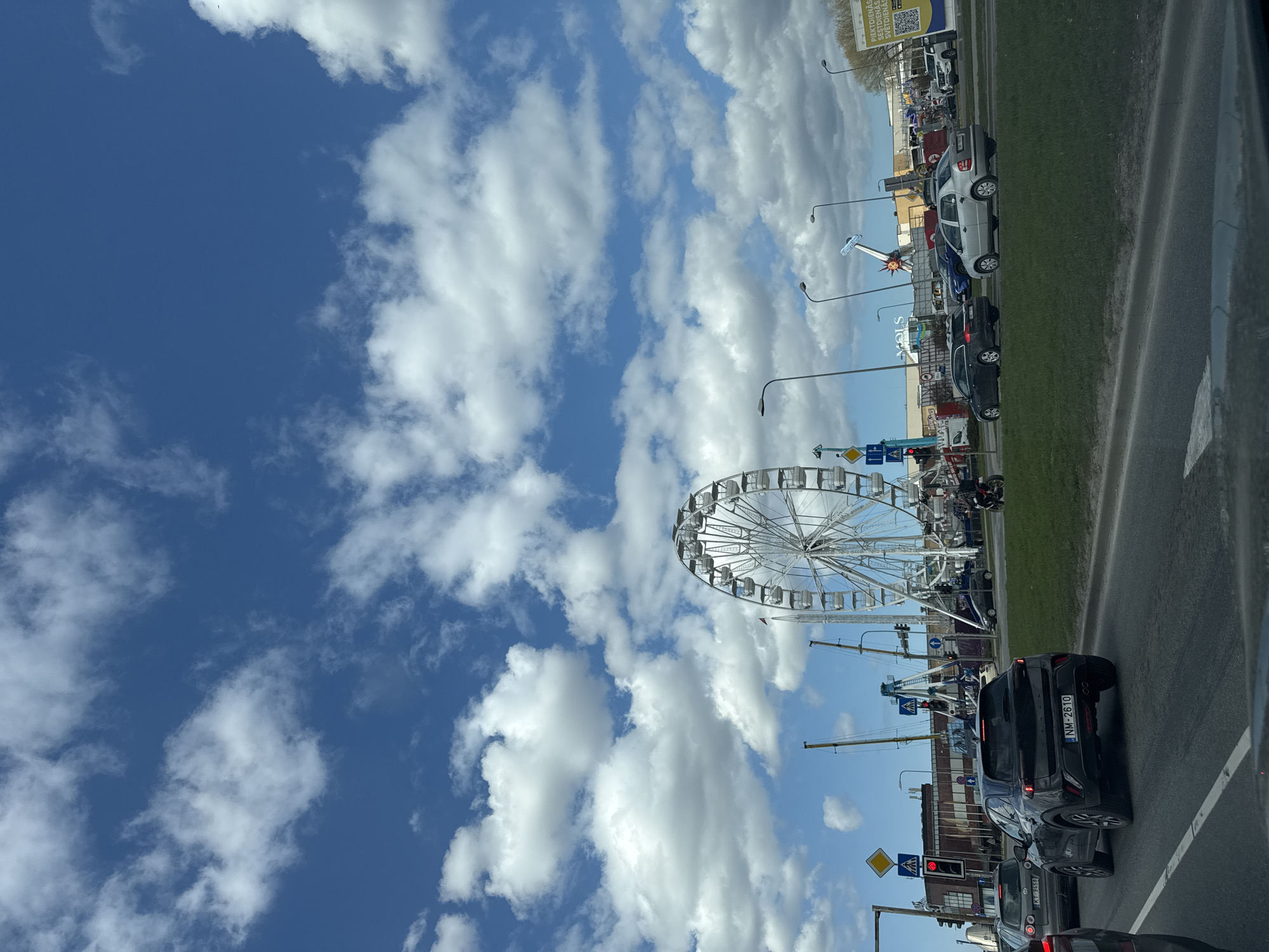 Ferris wheel operates in Riga amid morning traffic