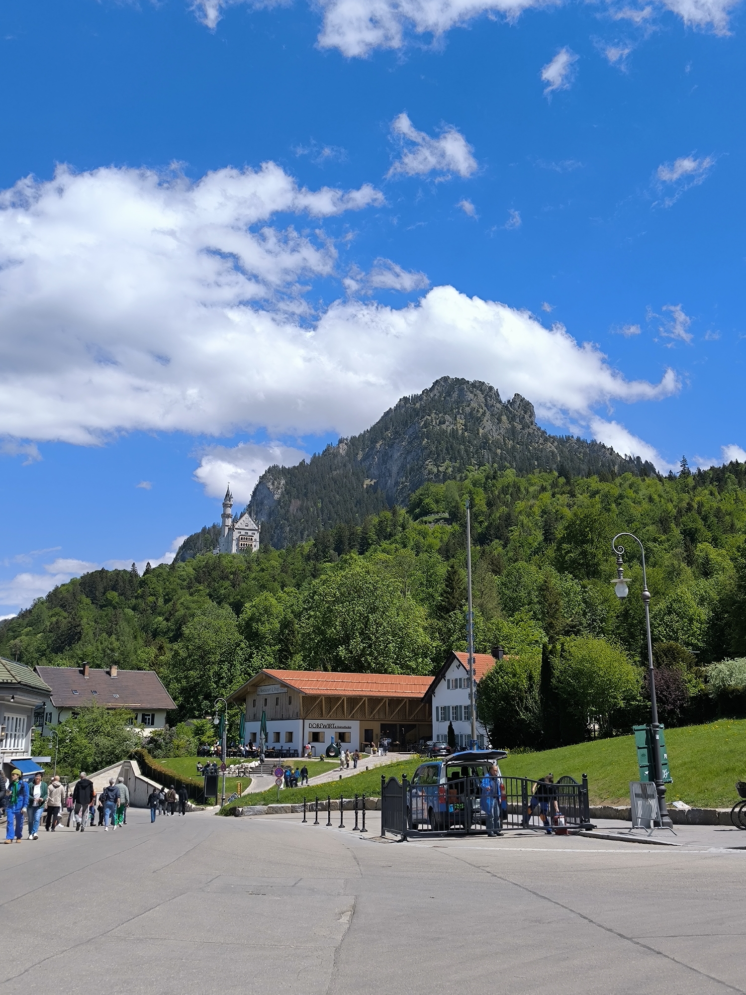 Tourist scenes captured in Schwangau featuring castle views, telescopes, carriages