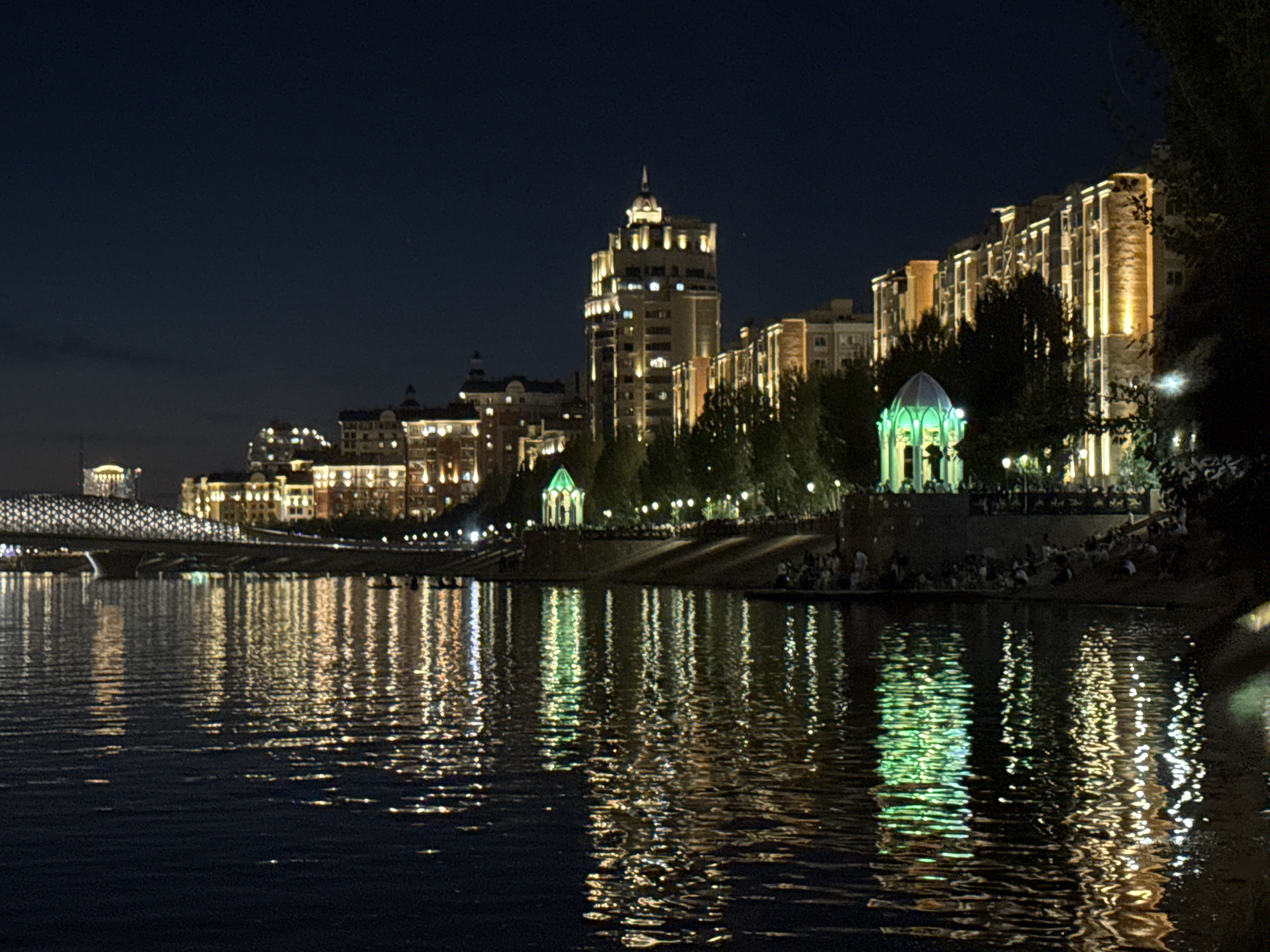 Astana's illuminated waterfront on a summer night