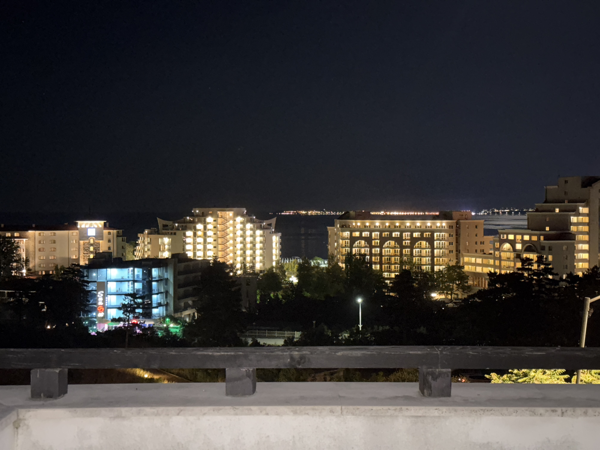 Nighttime resort pool and waterfront views from multiple angles