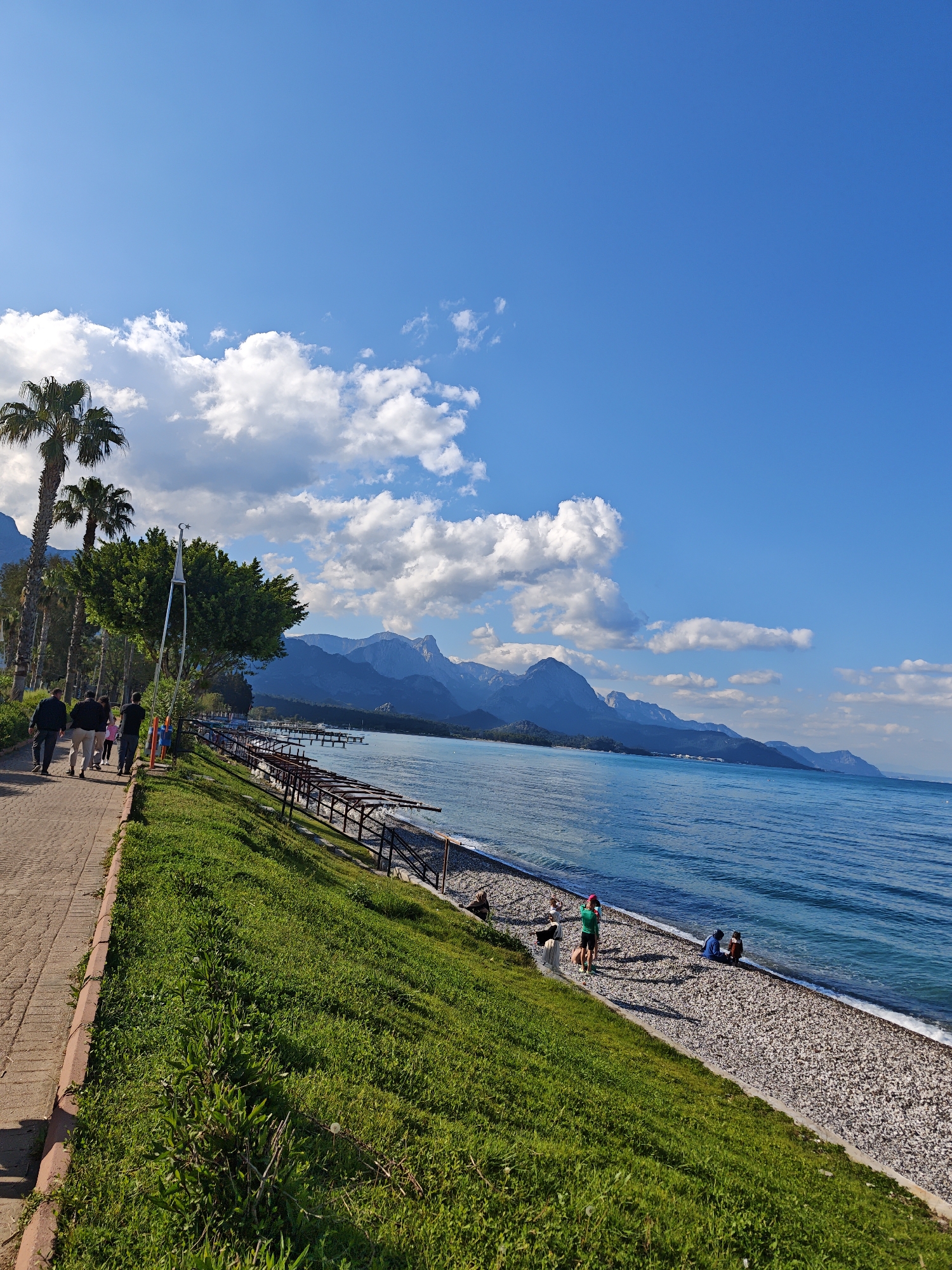 Tourist documents sunny afternoon stroll through Kemer, Turkey coastal town