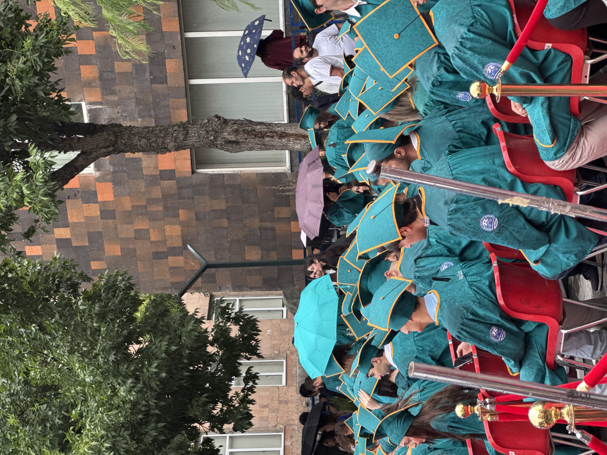 Outdoor graduation ceremony in Yerevan, teal gowns and roses