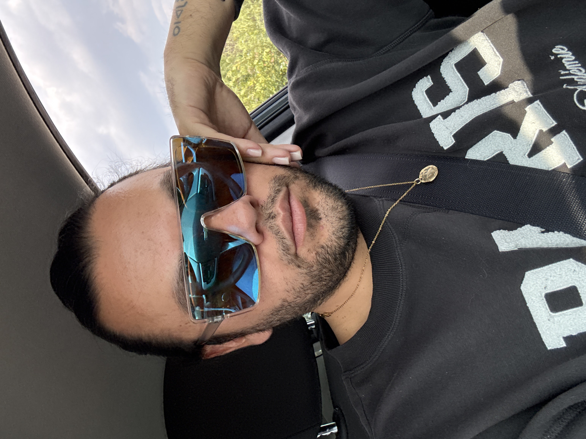 Person in vehicle wearing sunglasses and jewelry in Mexico