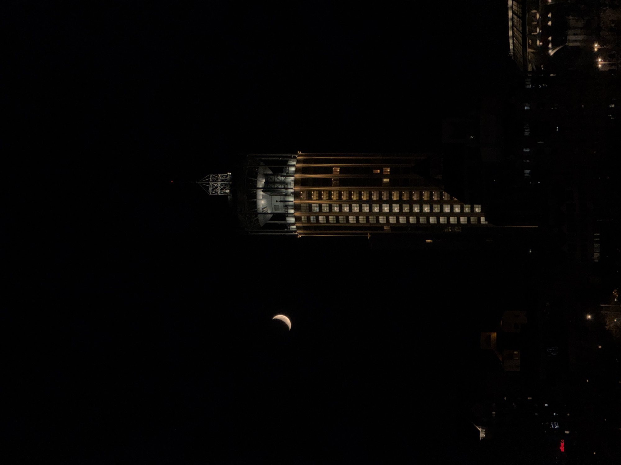Illuminated building photographed against Moscow night sky