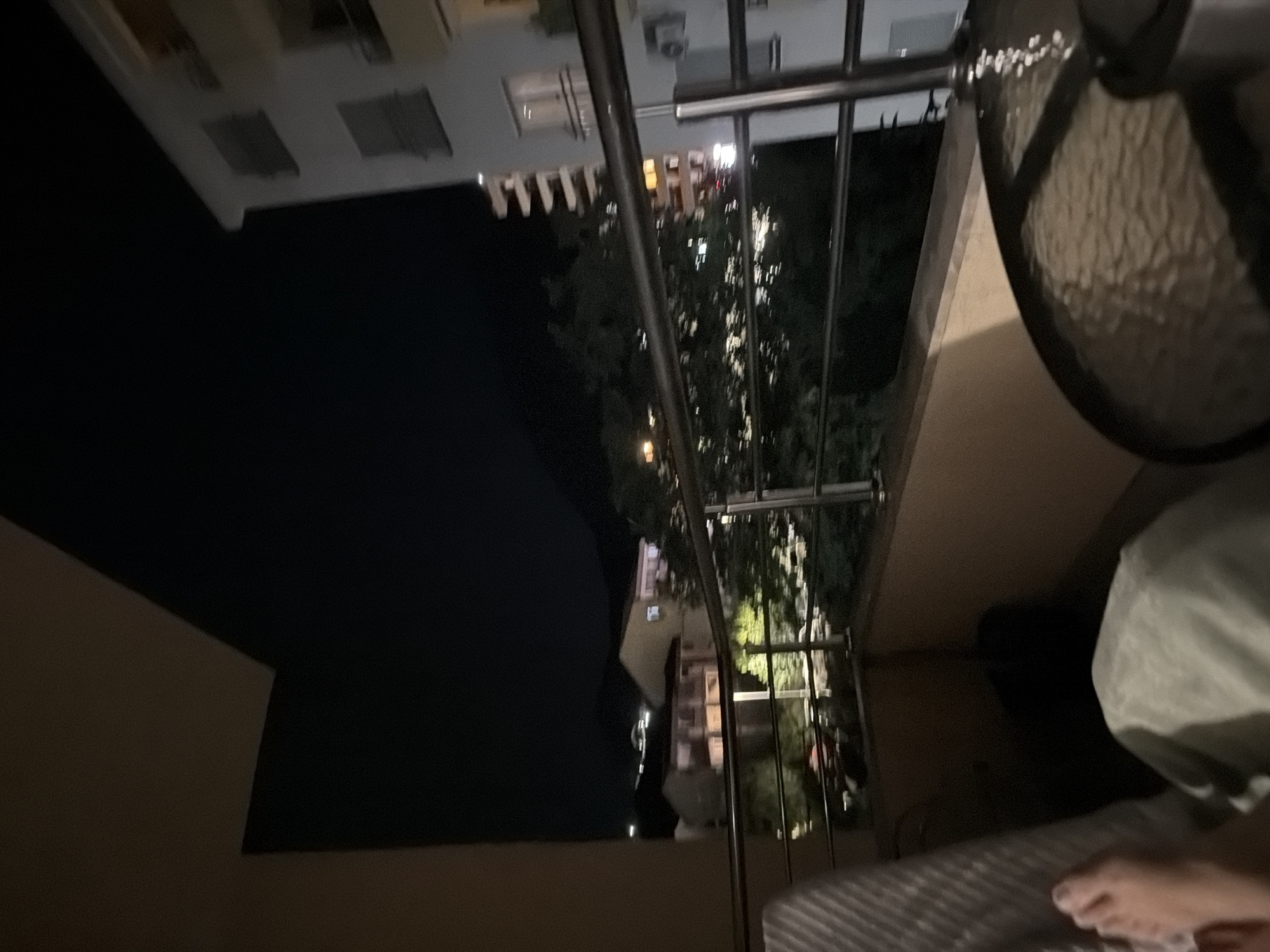 Evening balcony relaxation overlooking nighttime Budva residential streets