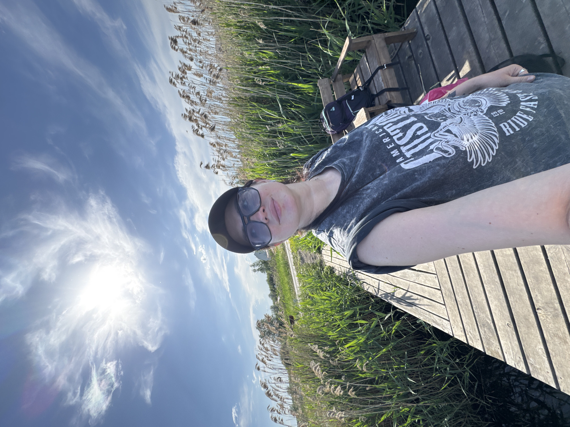 Couple enjoys fishing and selfies on sunny dock afternoon