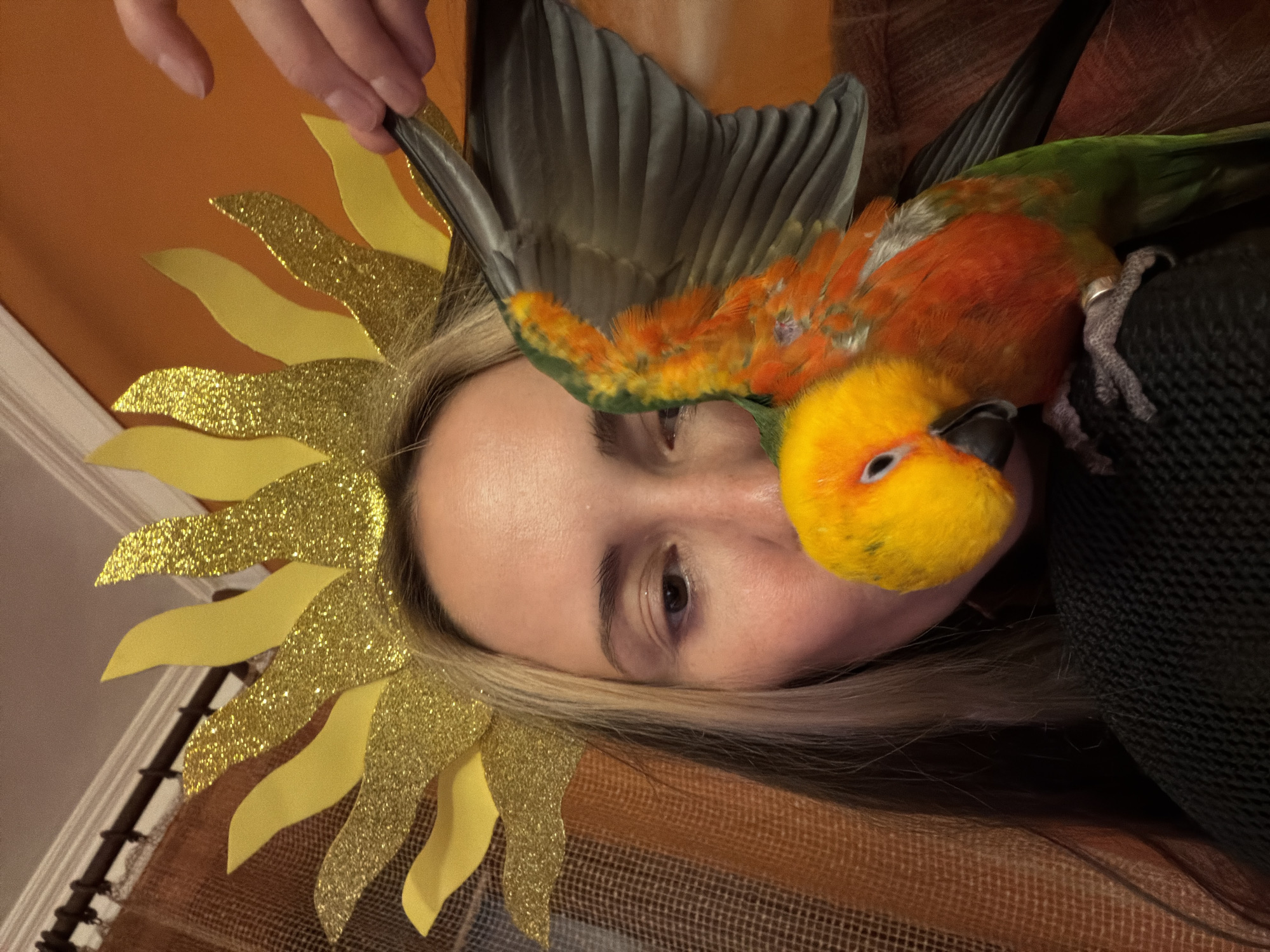 Person poses with pet parrot in Khimki indoor portrait