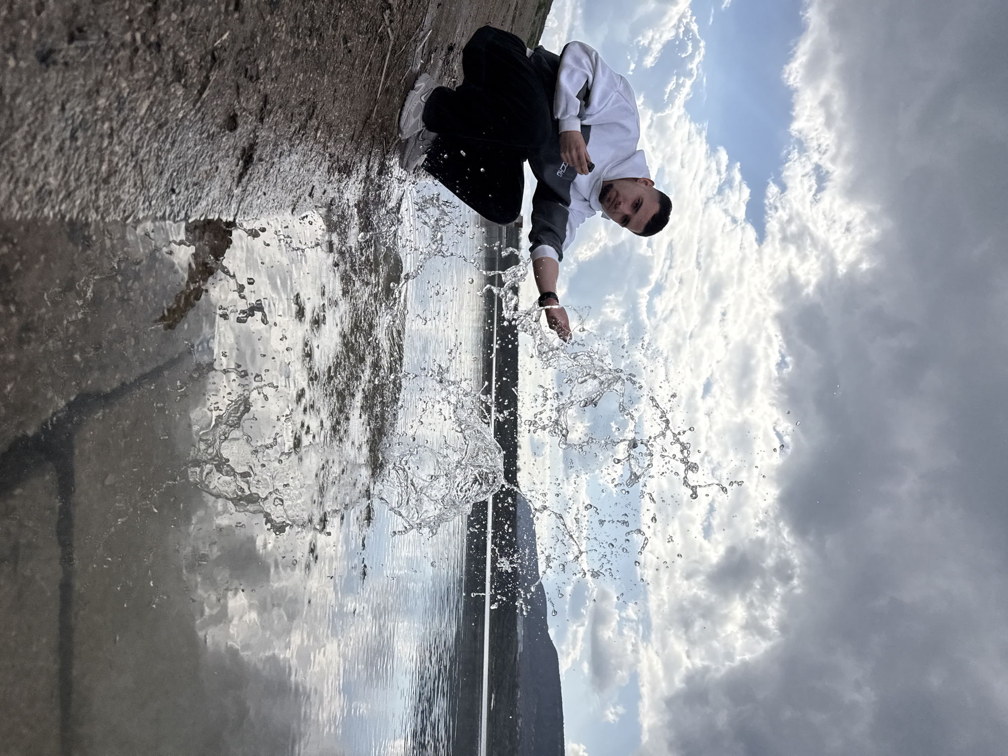 Man splashes water by hand near Shumen, Bulgaria waterway