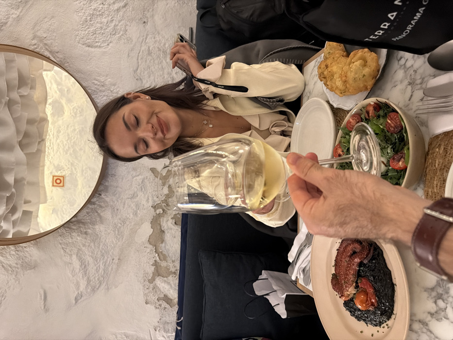 Woman enjoys dinner and wine at Porto restaurant