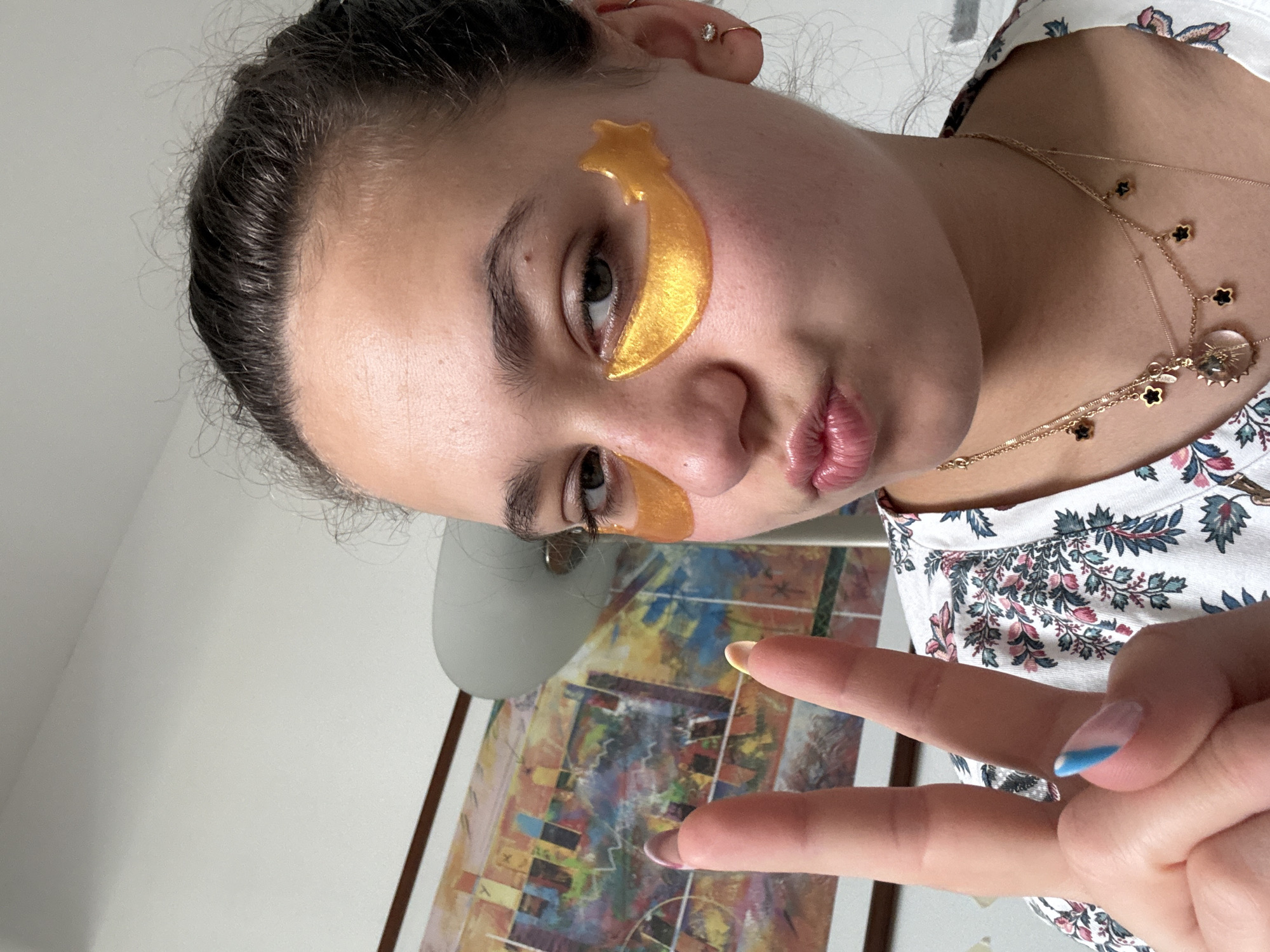 Woman poses with gold star eye patches in Milan