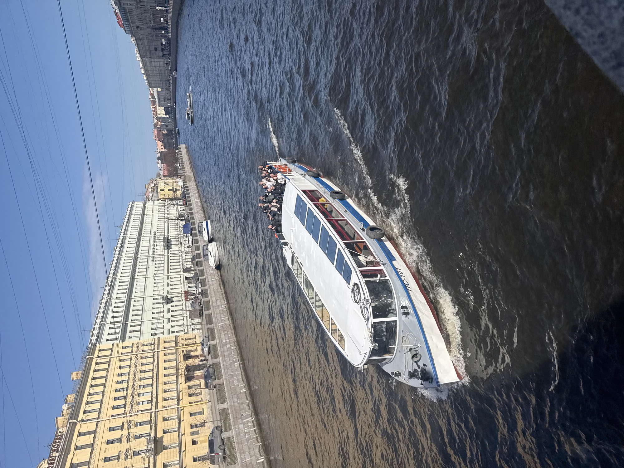 Tourist boats navigate Saint Petersburg canals on sunny morning
