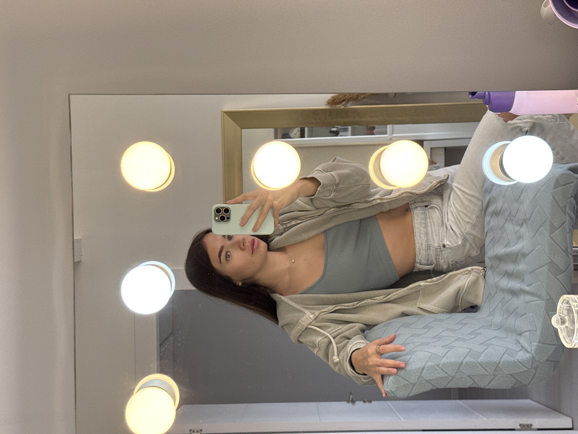 Woman takes mirror selfie in Ramat Gan bathroom