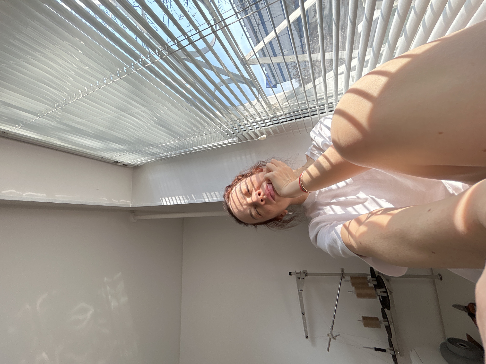Woman rests in sunlit room in Chaikovsky, Russia