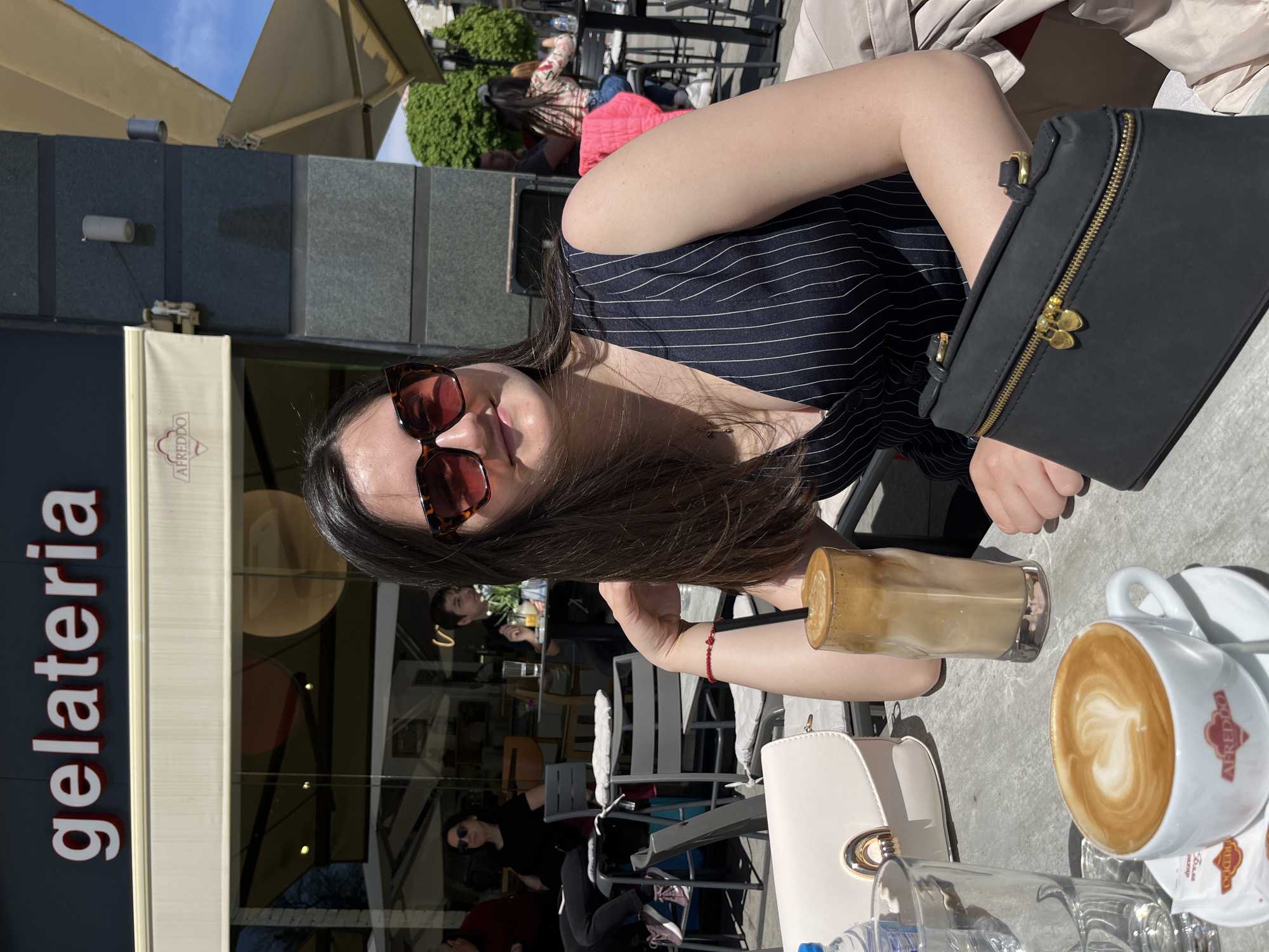 Woman enjoys sunny morning at Plovdiv cafe