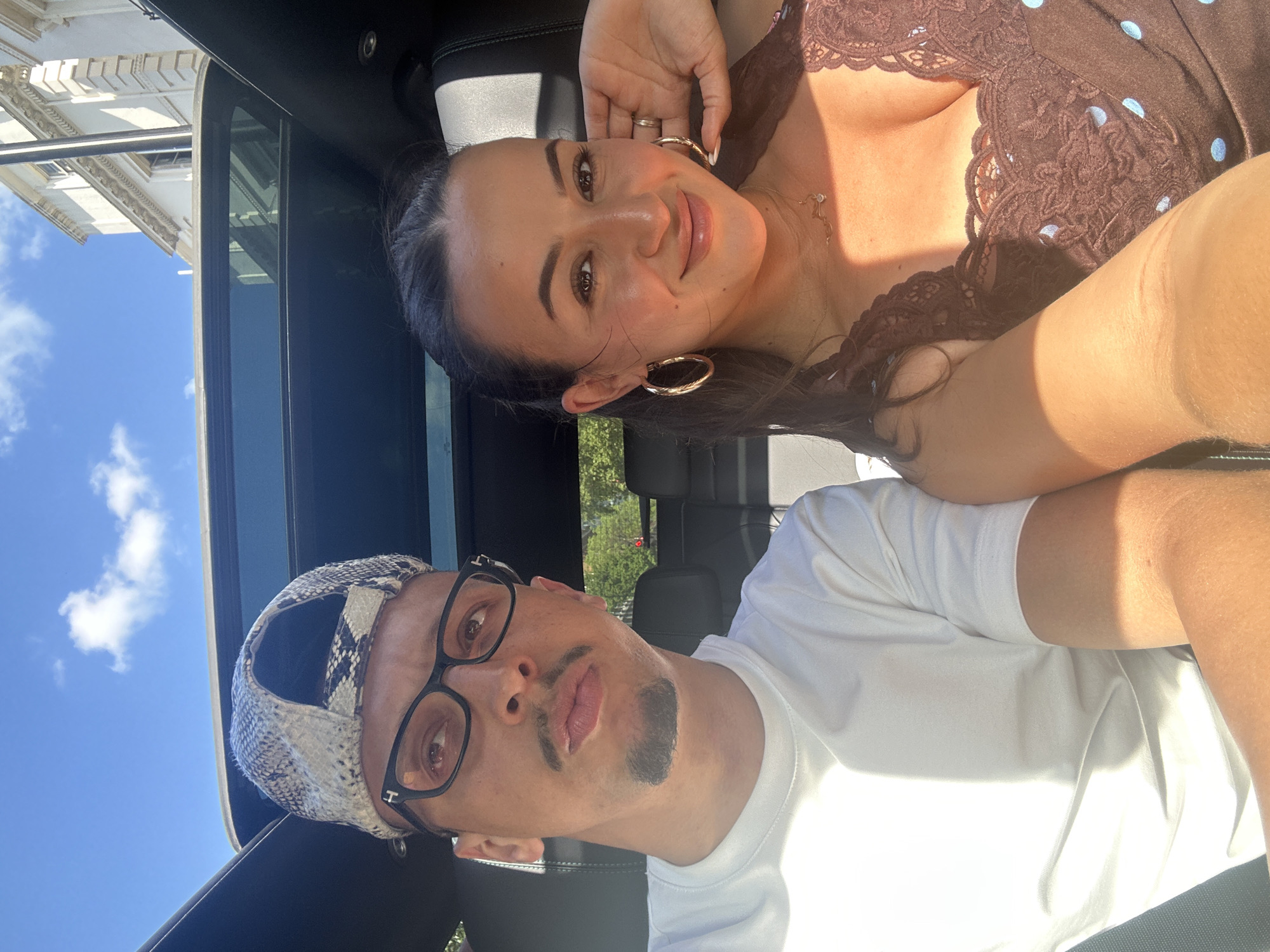 Couple enjoys sunny afternoon drive in London convertible