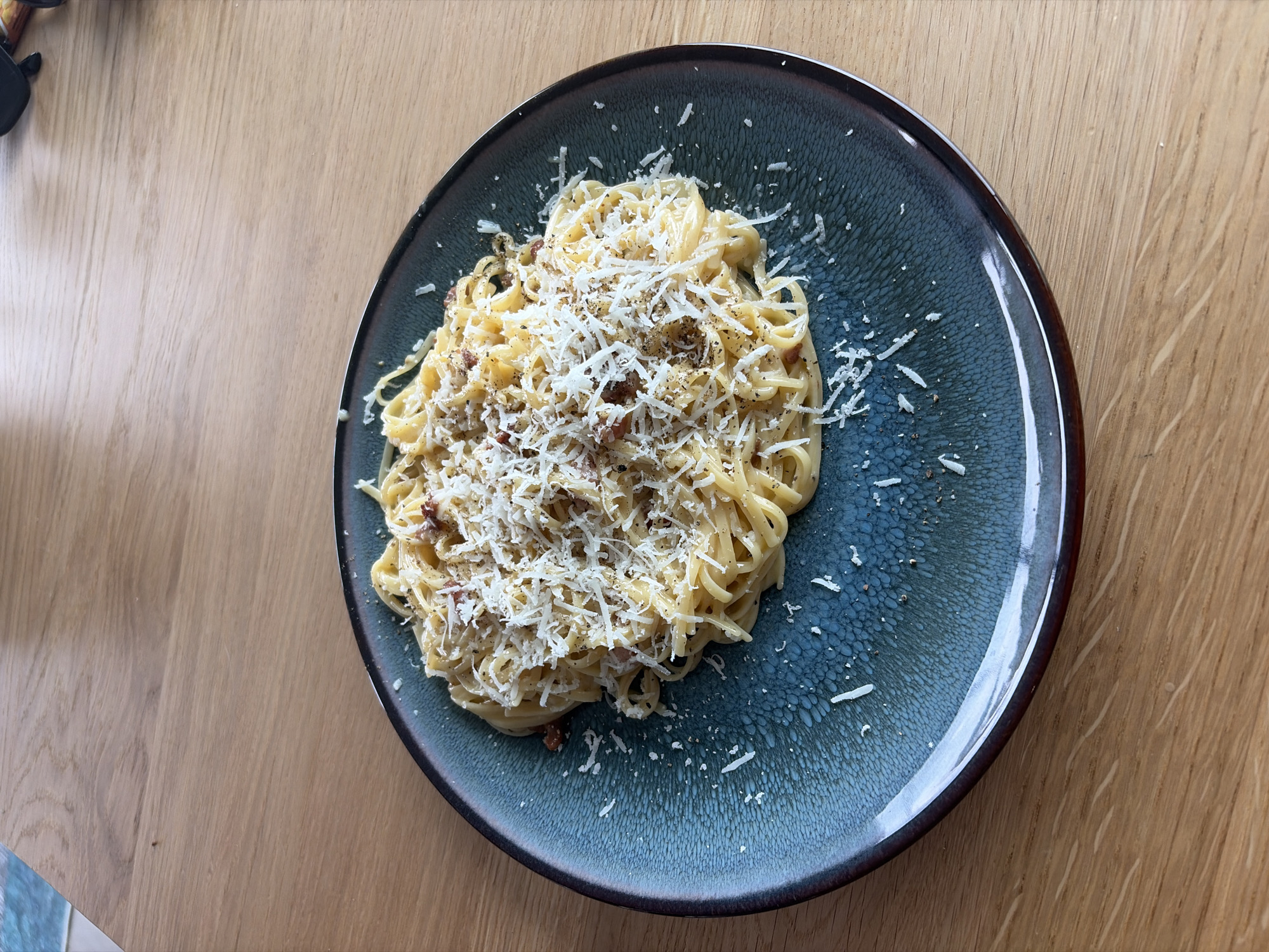Spaghetti carbonara up close on a wooden table in Rijswijk