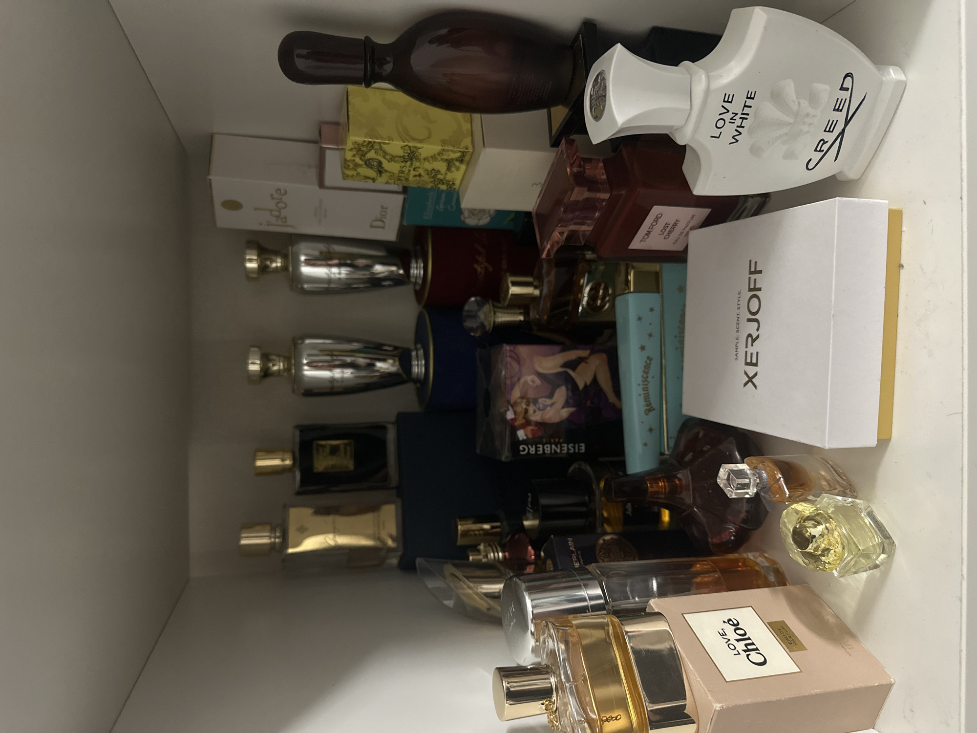 Luxury perfume collection documented on shelves in Riga
