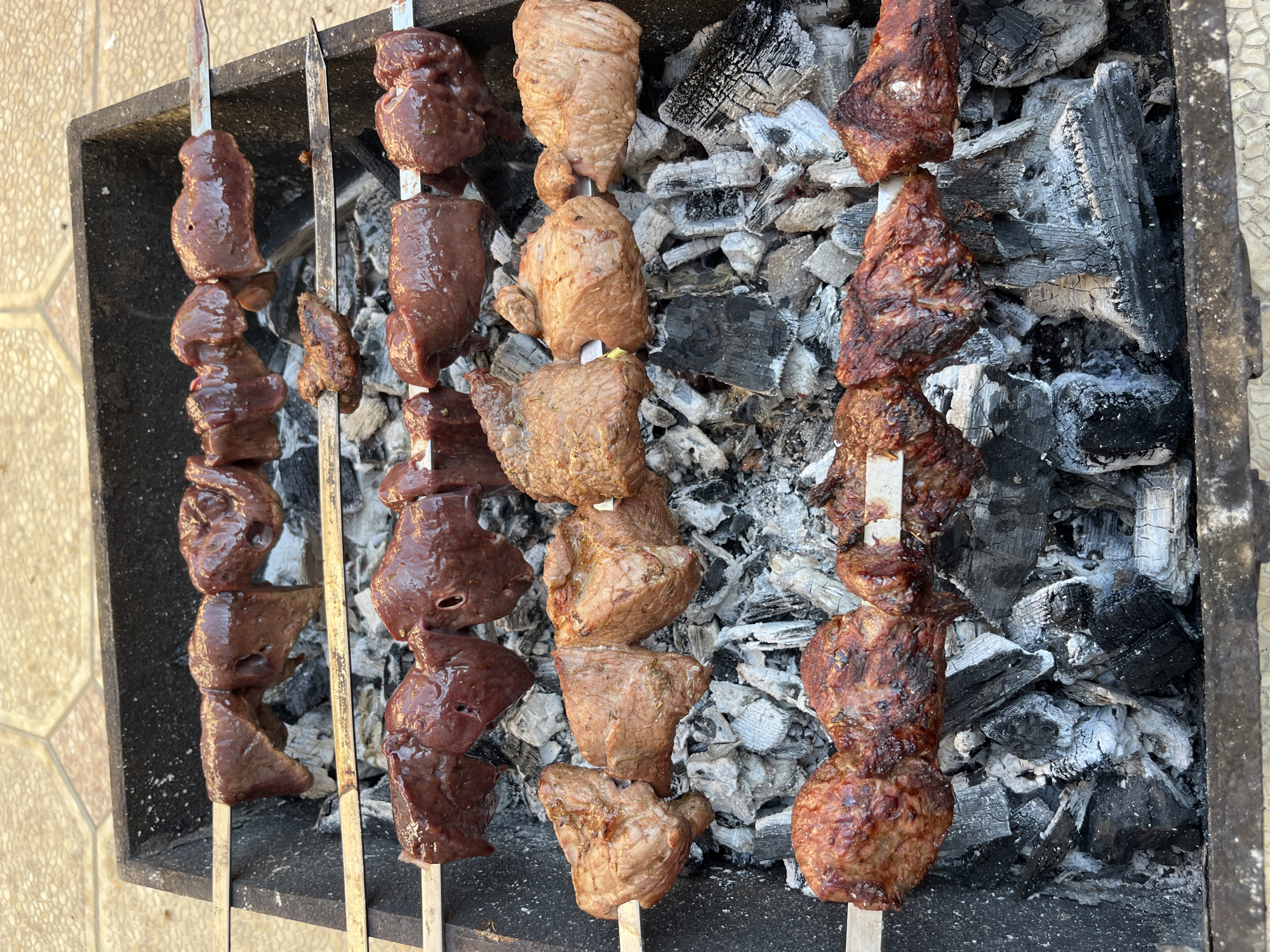 Outdoor barbecue cooking session documented in Kaspiysk, Russia