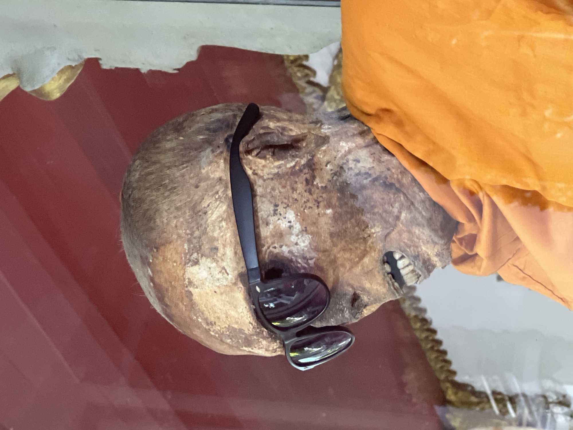 Mummified monk display and traditional blessings at Baan Hua Thanon temple