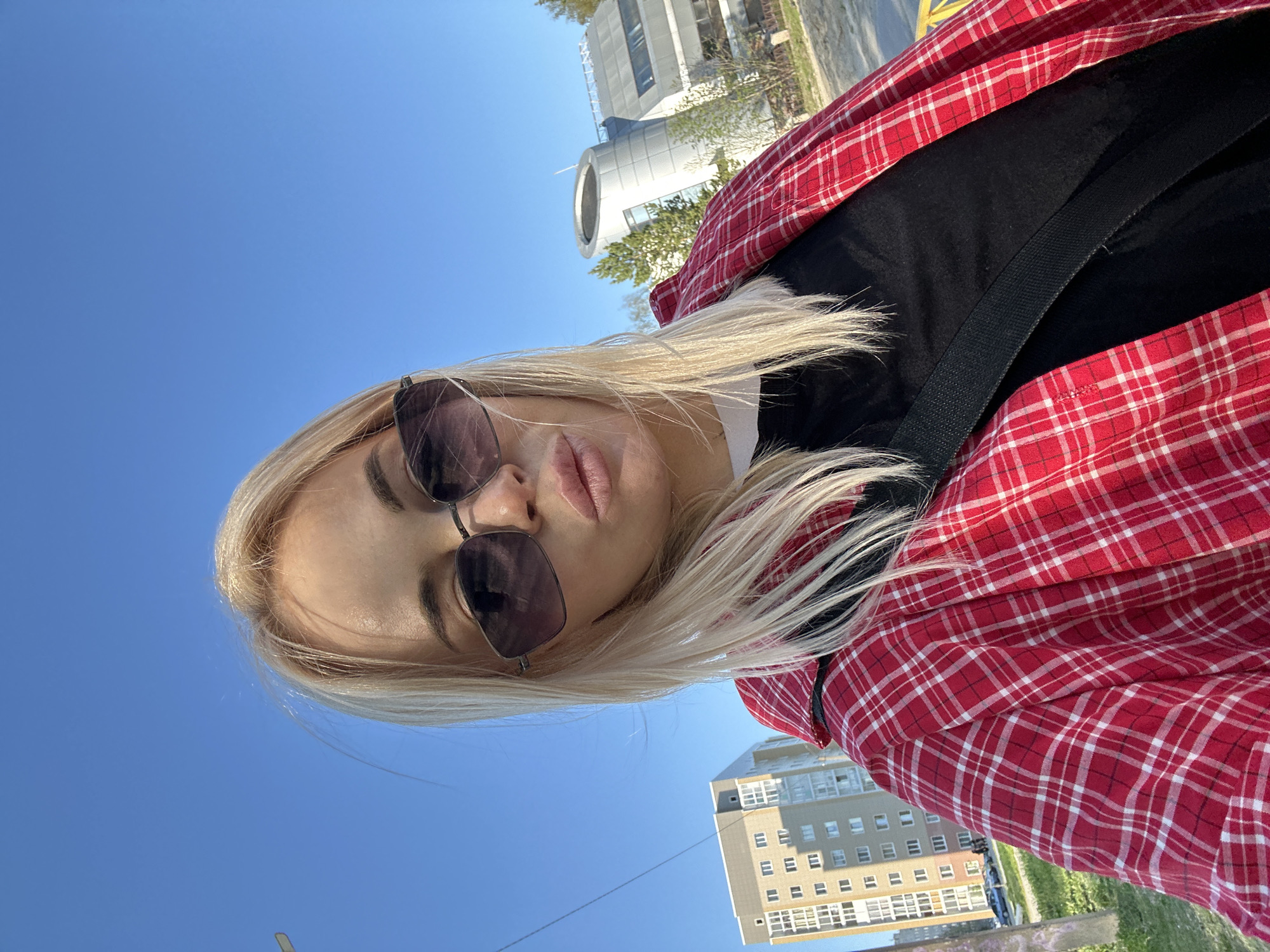 Woman takes selfies around Megion apartment buildings during casual outing
