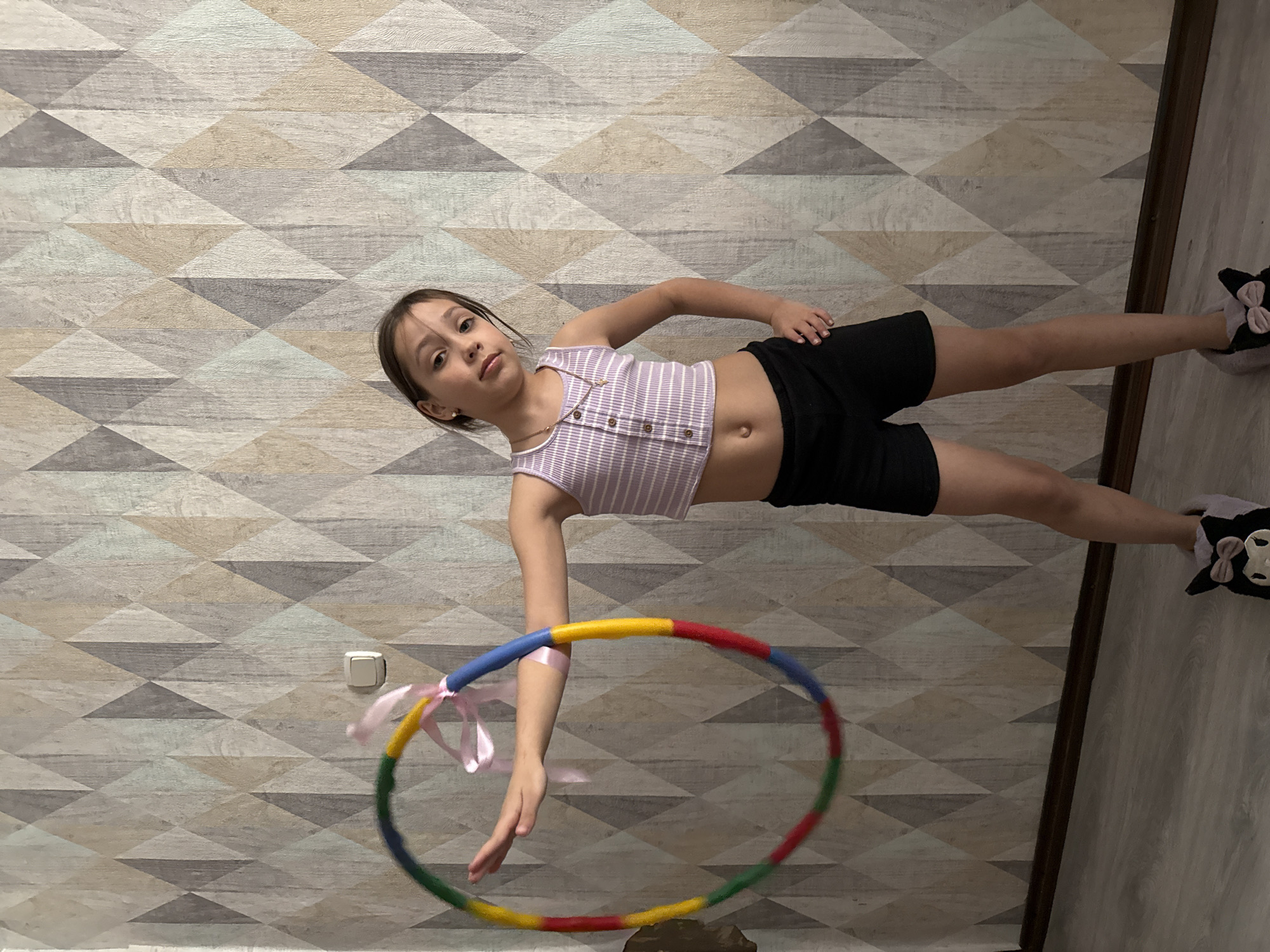 Girl practices gymnastics with dressed cat in Votkinsk home