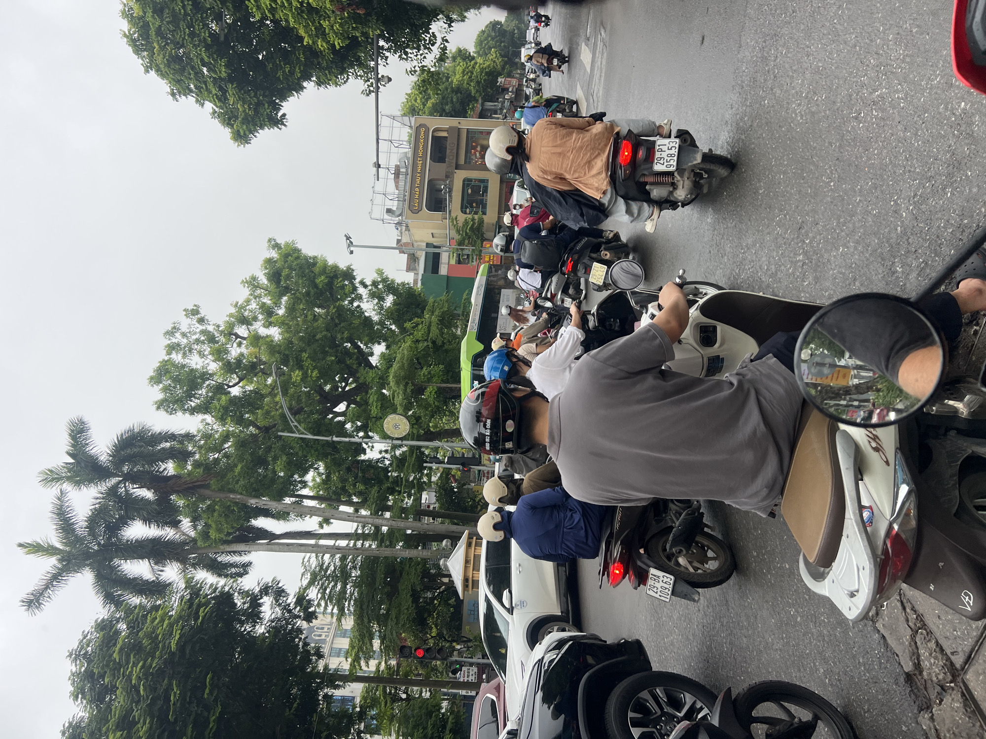 Busy Hanoi streets near government buildings on a wet morning