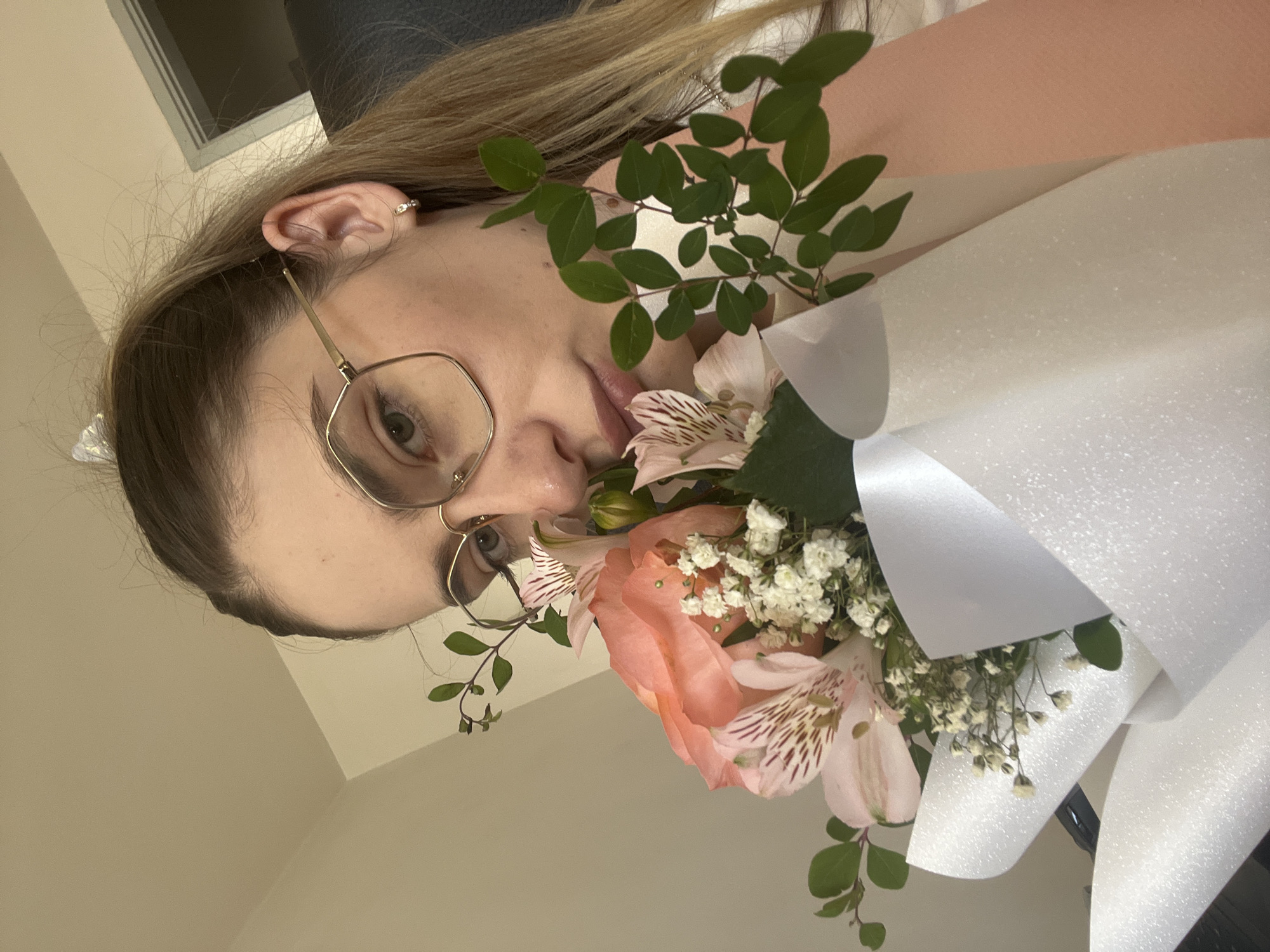 Up close with a fresh bouquet of peach roses and pink flowers