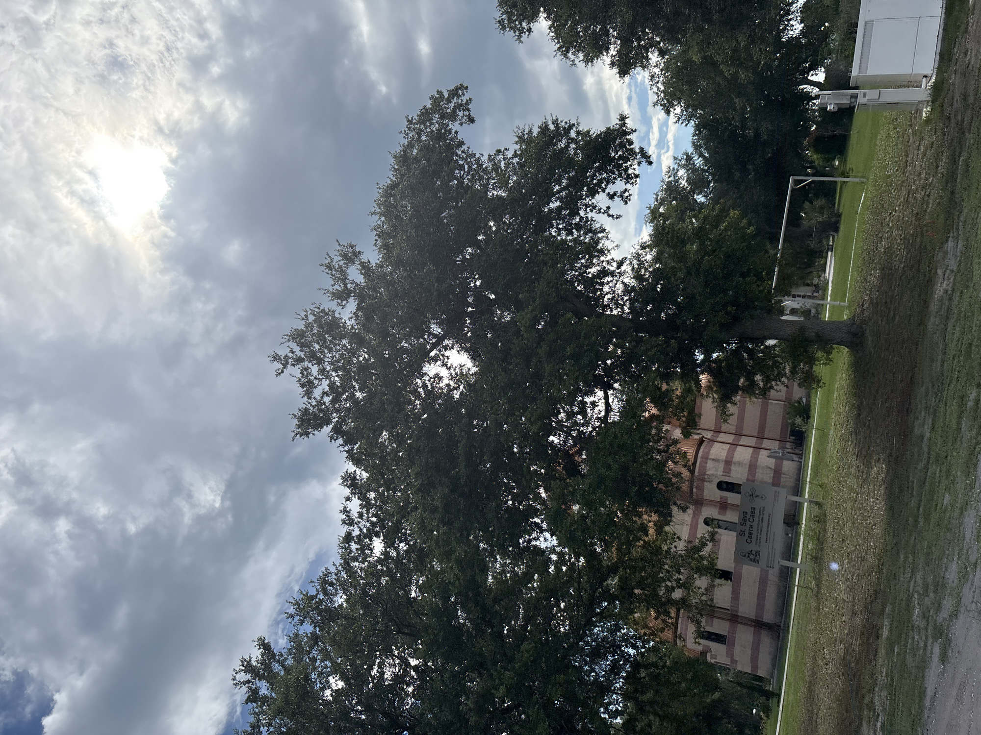 Ornate domed church rises above North Port's summer tree canopy