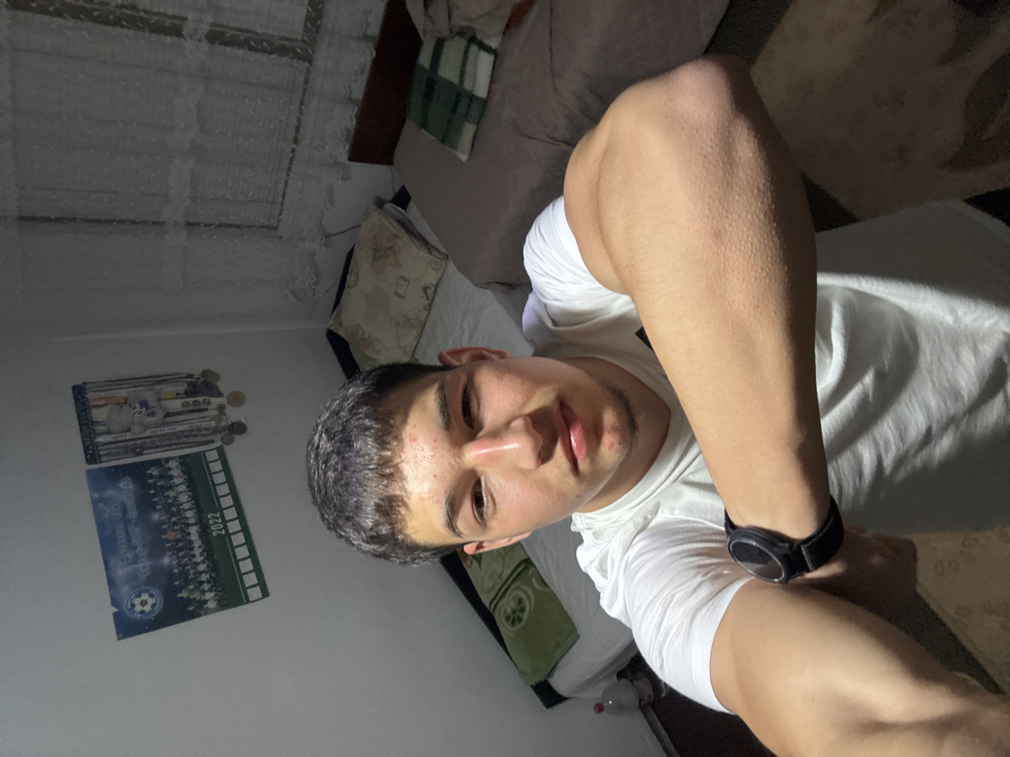 Young man takes selfies in bedroom in Zlatograd