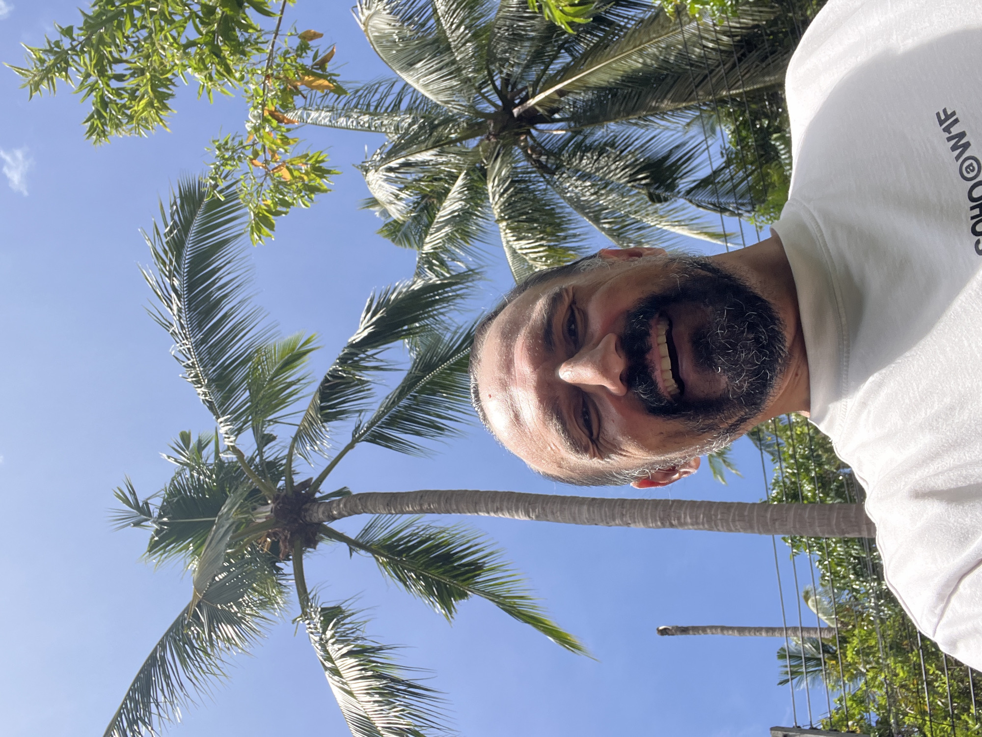 Man poses for photos in Thai village setting