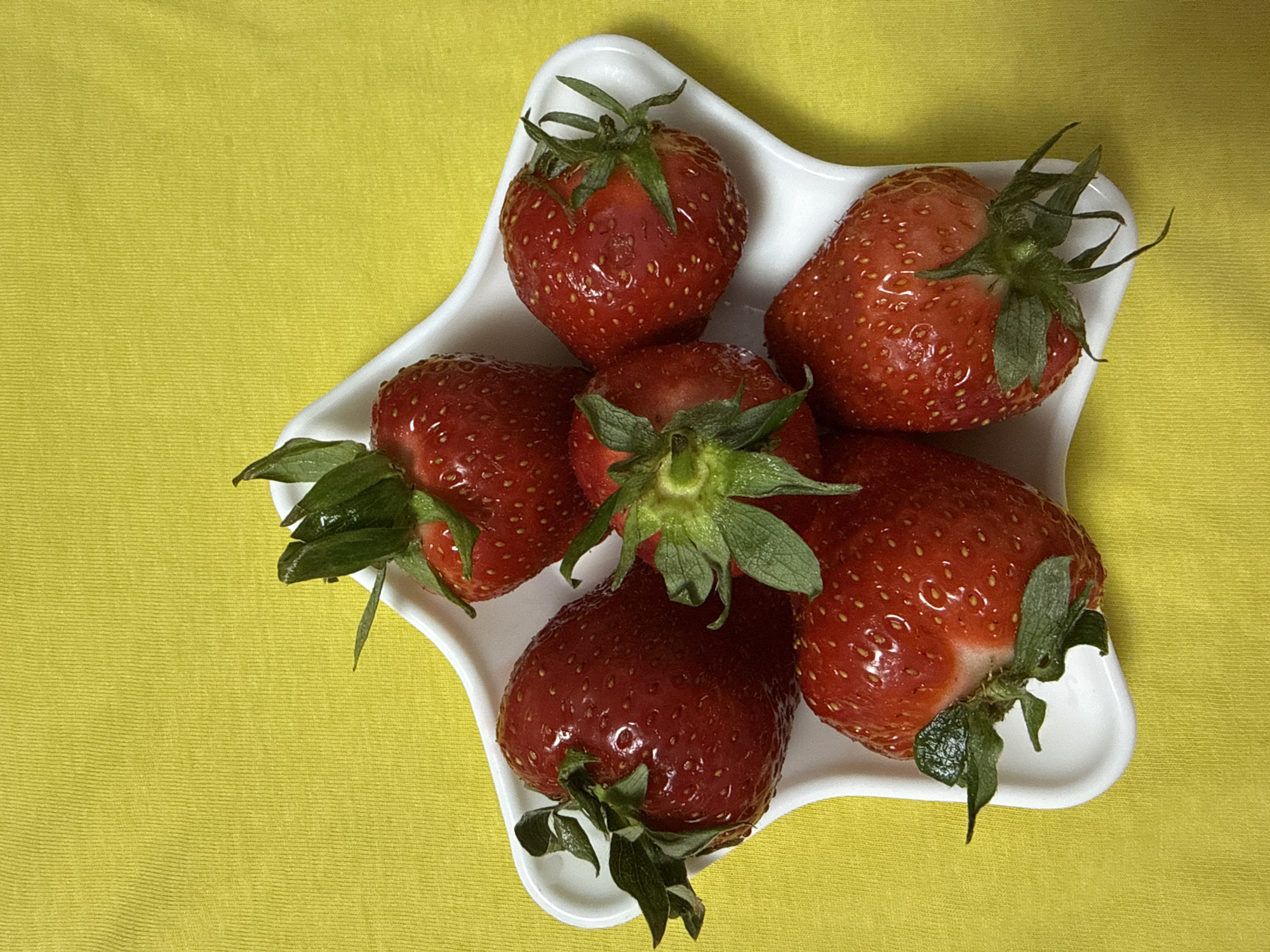 Fresh strawberries photographed in white dishes in Chaikovsky, Russia