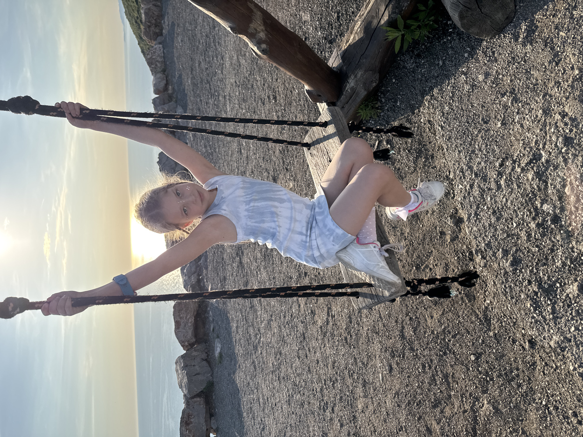 Child swings at sunset in Montenegro countryside