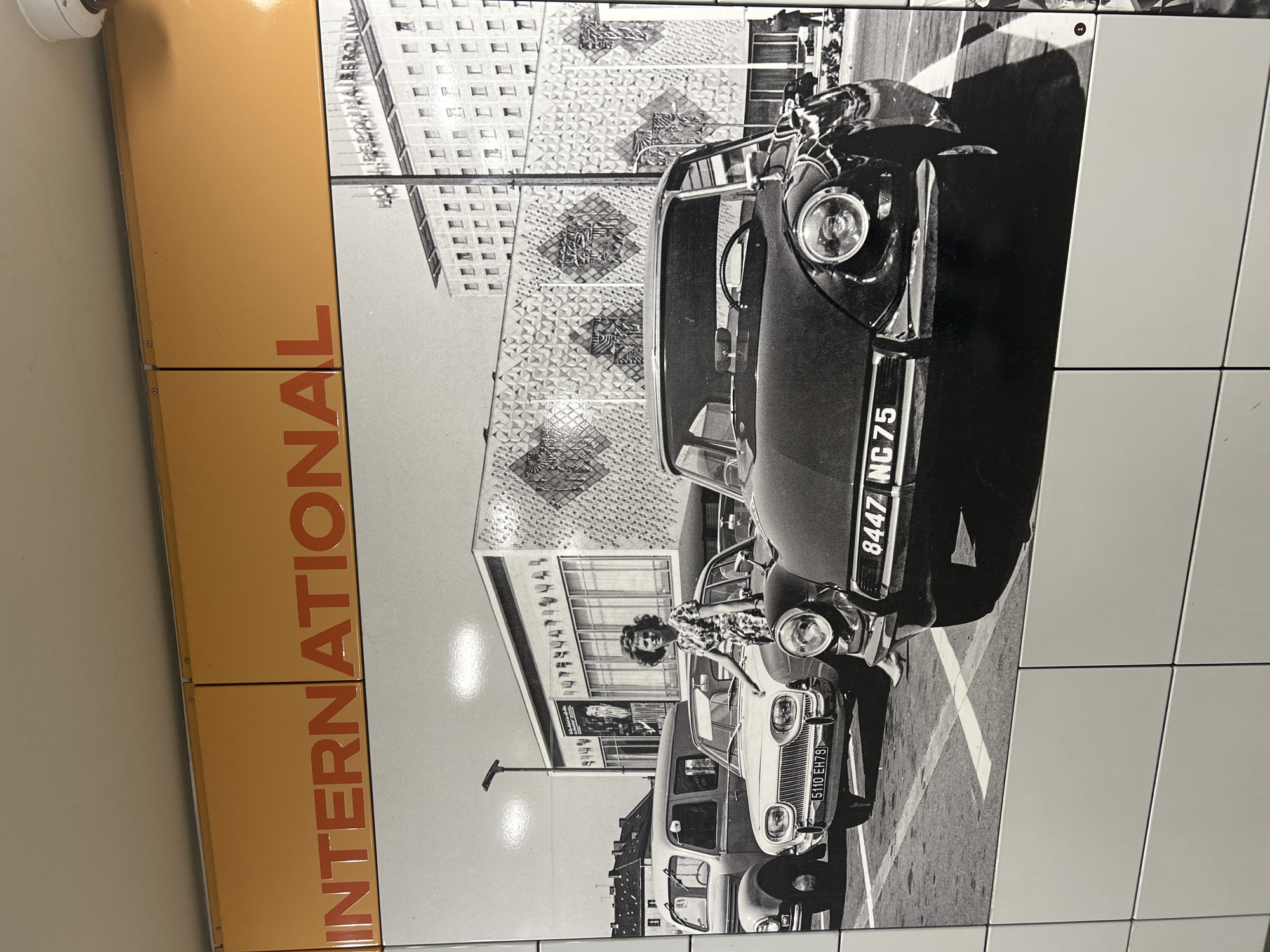 Berlin transit station displays international signage, tango concert poster