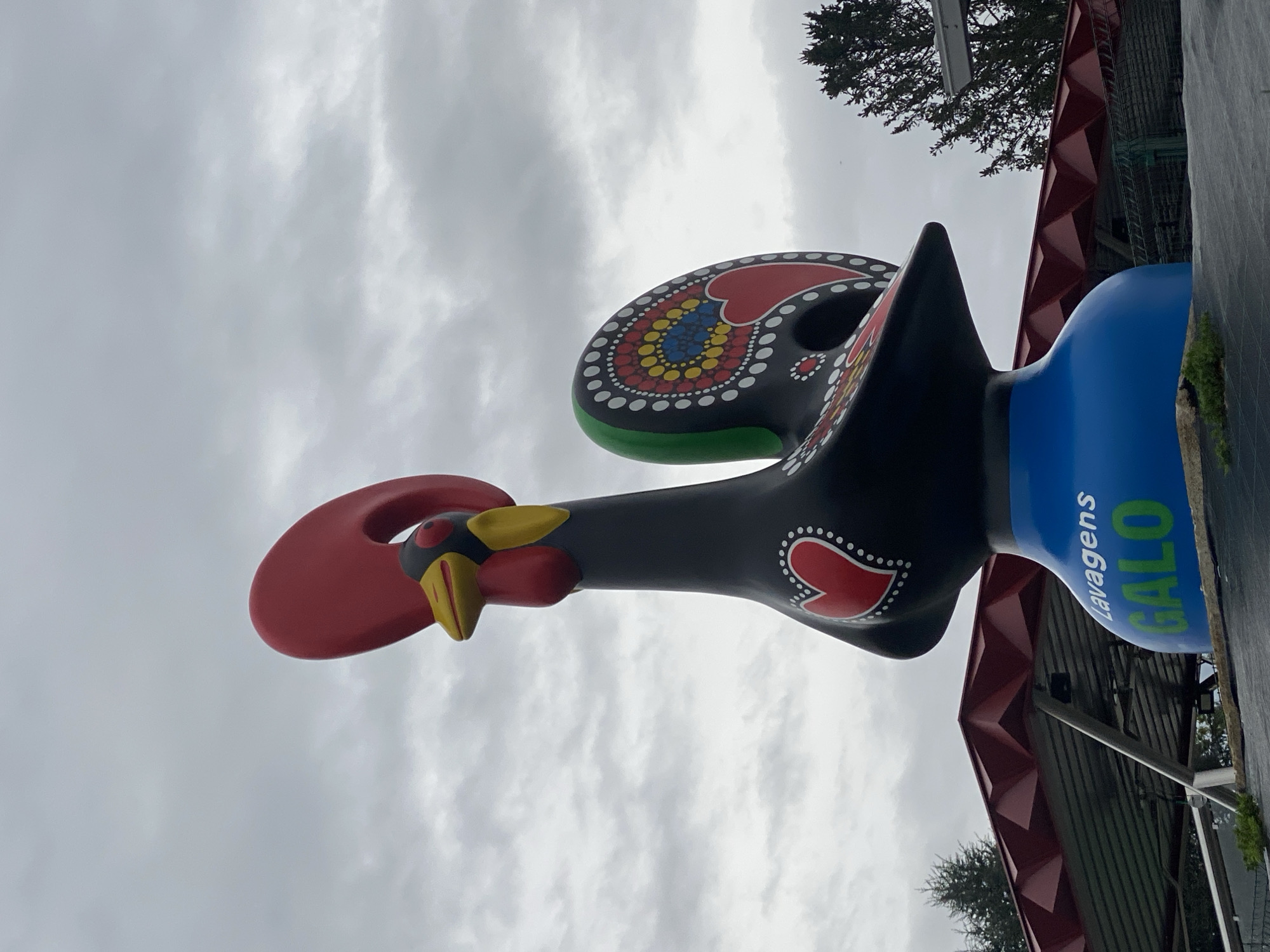Tourists document famous Barcelos rooster statue in Portugal