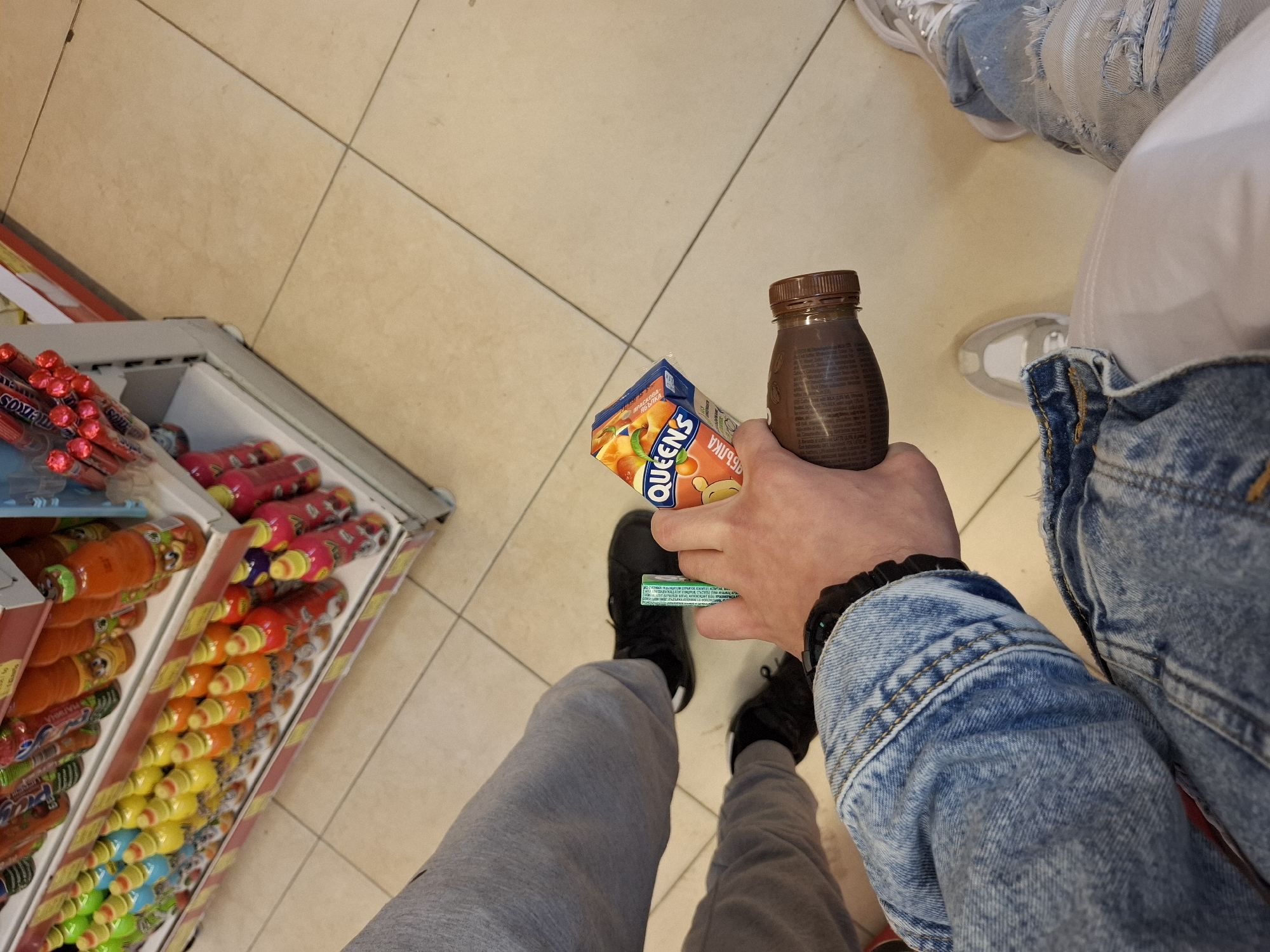Shopper selects beverages at Veliki Preslav store