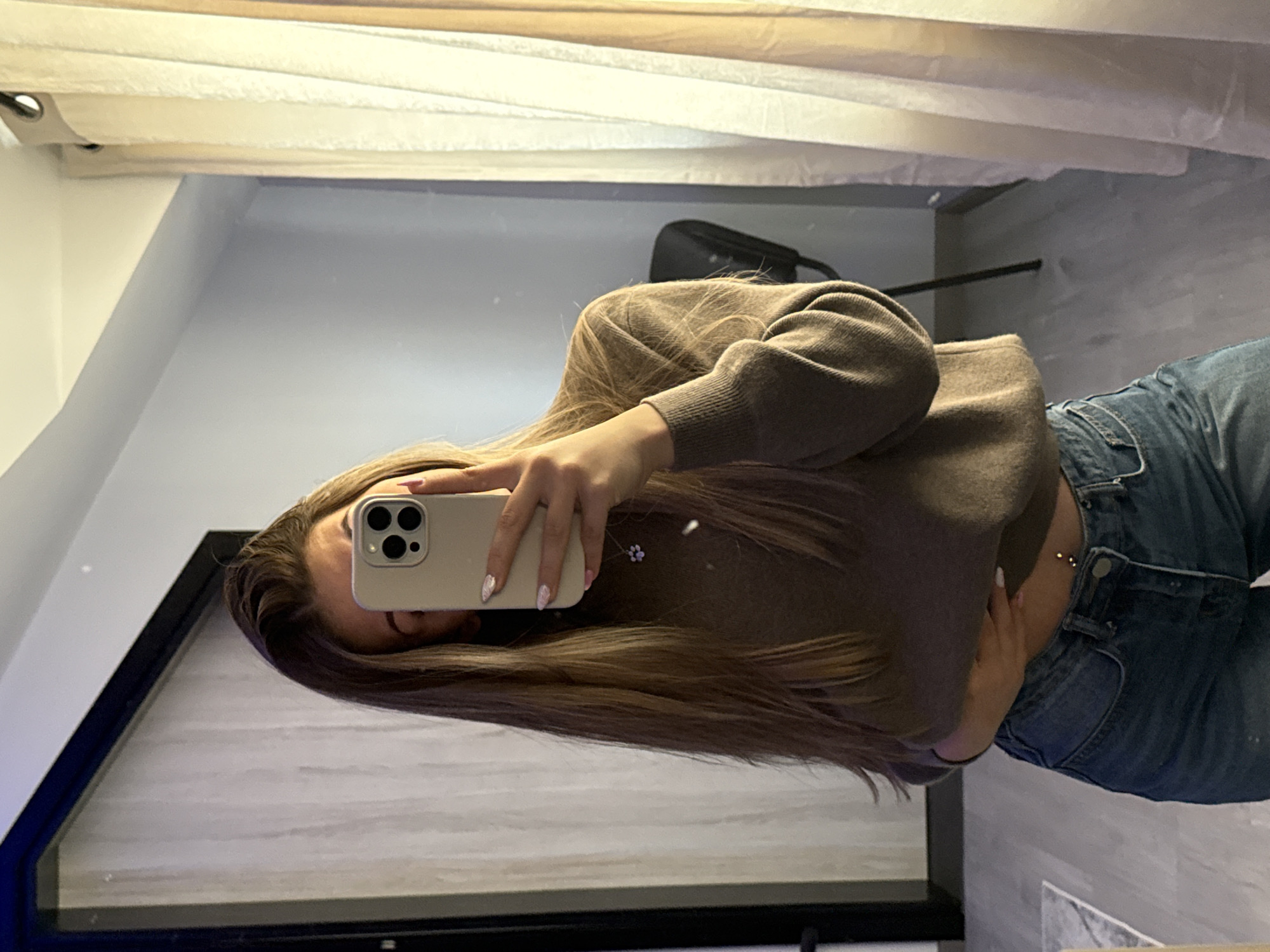 Woman takes mirror selfie at home in Bulgaria