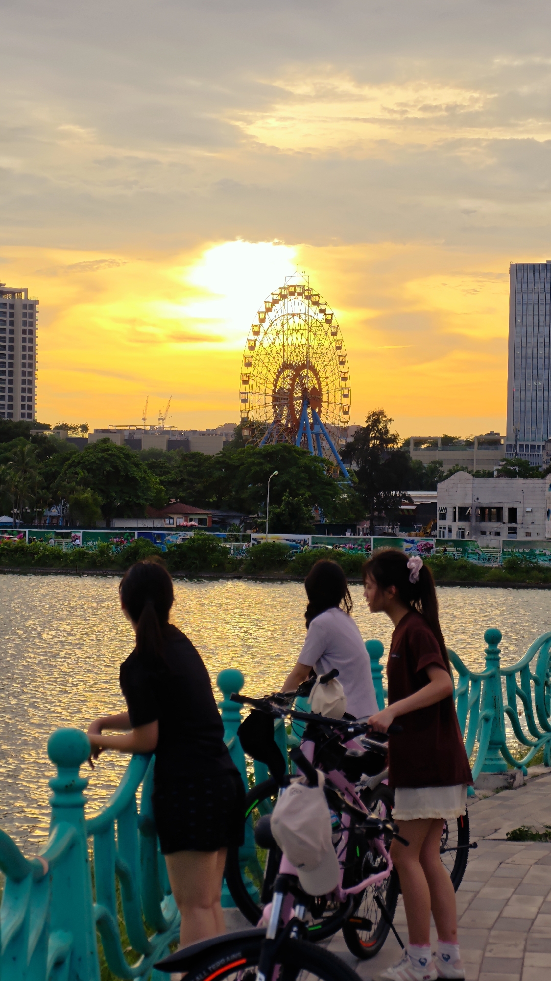 Afternoon along Hanoi's waterfront: bikes, blooms, and city streets