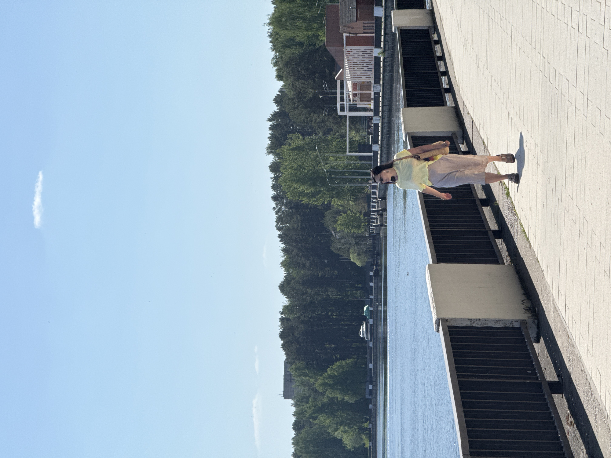 Morning stroll captured along waterfront promenade with mermaid sculptures