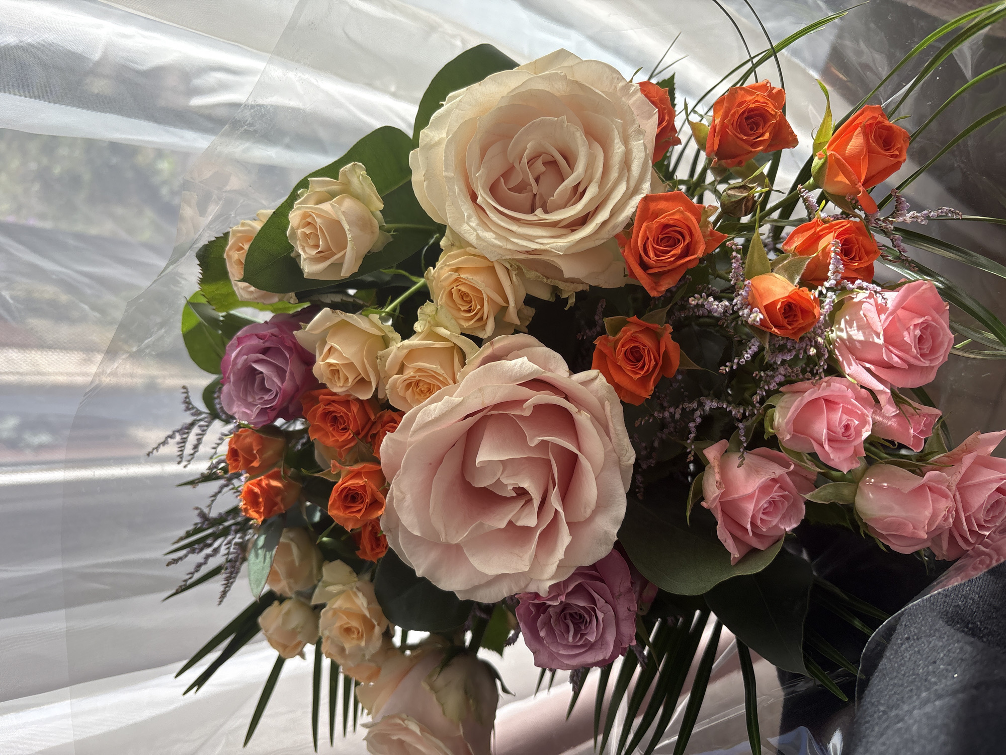 Colorful rose bouquet spotted by window in Veghel