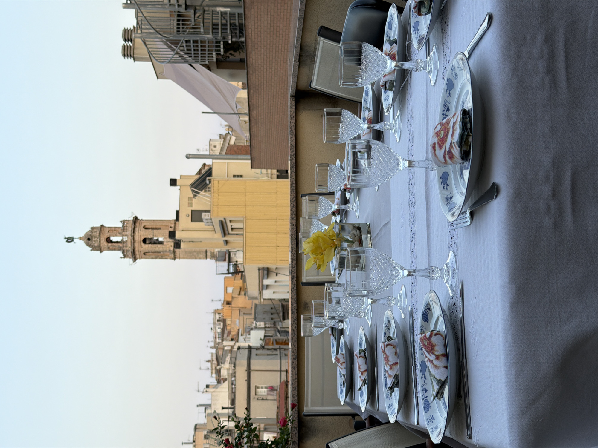 Rooftop table set for dinner overlooking El Vendrell