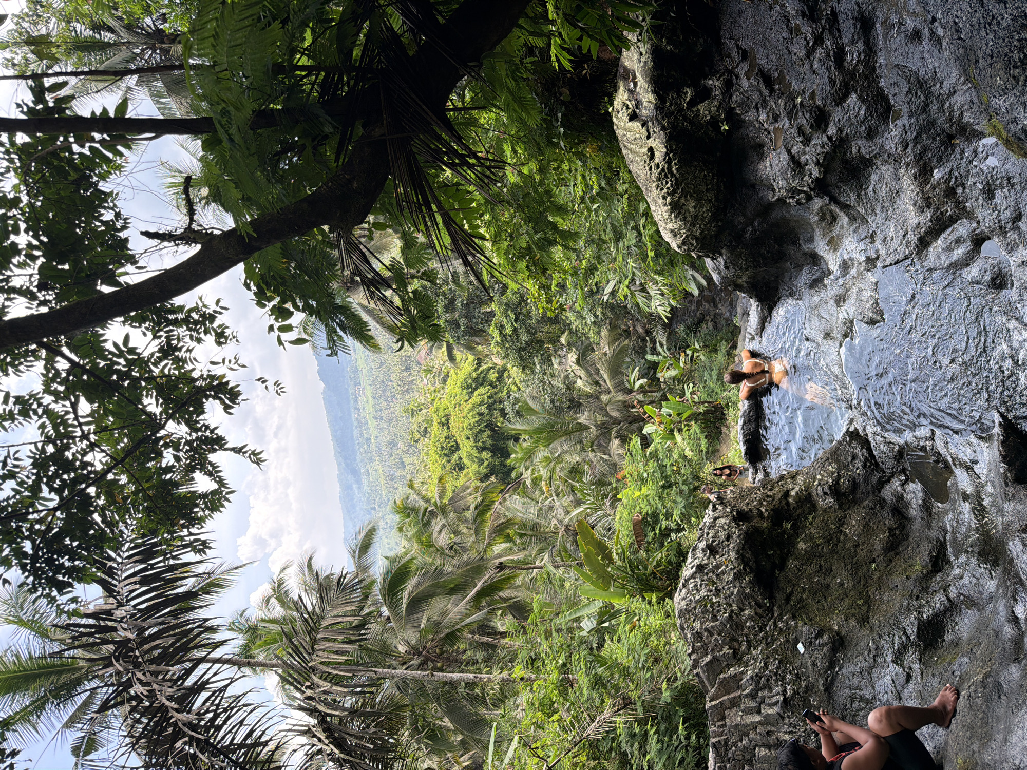 Tourist documents scenic stairway descent to natural pool in Sidemen