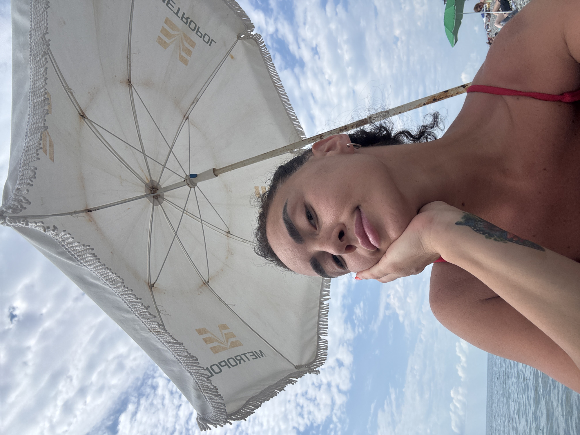 Relaxing on Batumi's pebble beach on a cloudy summer day