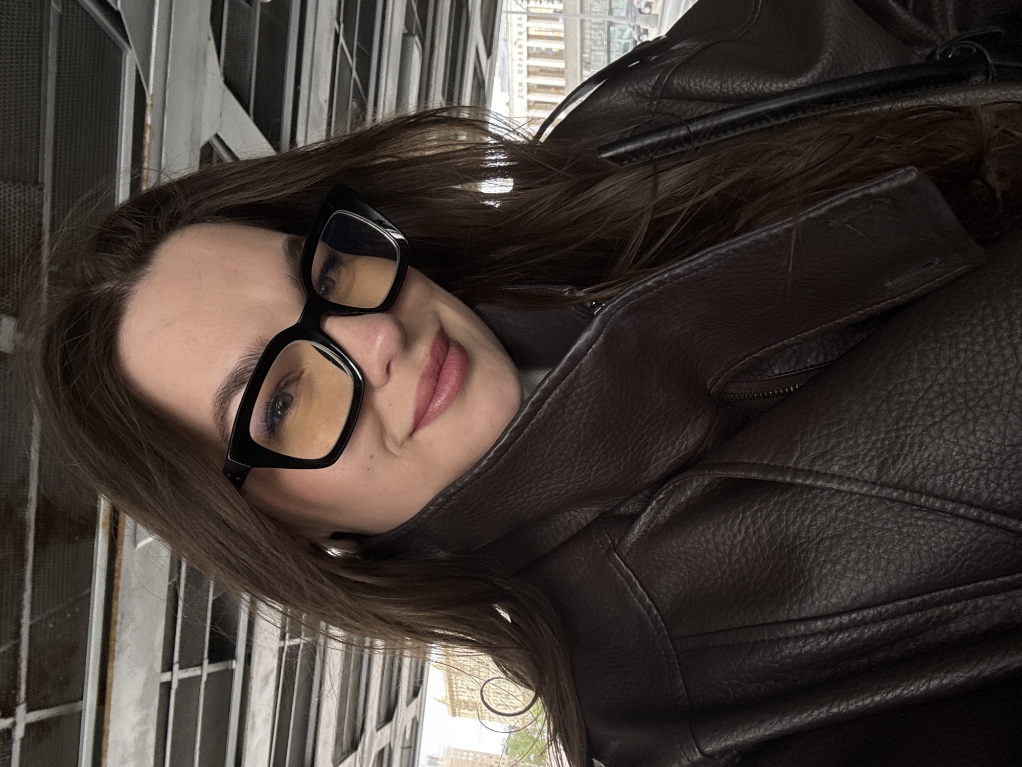 Woman photographed near white steel building in Moscow