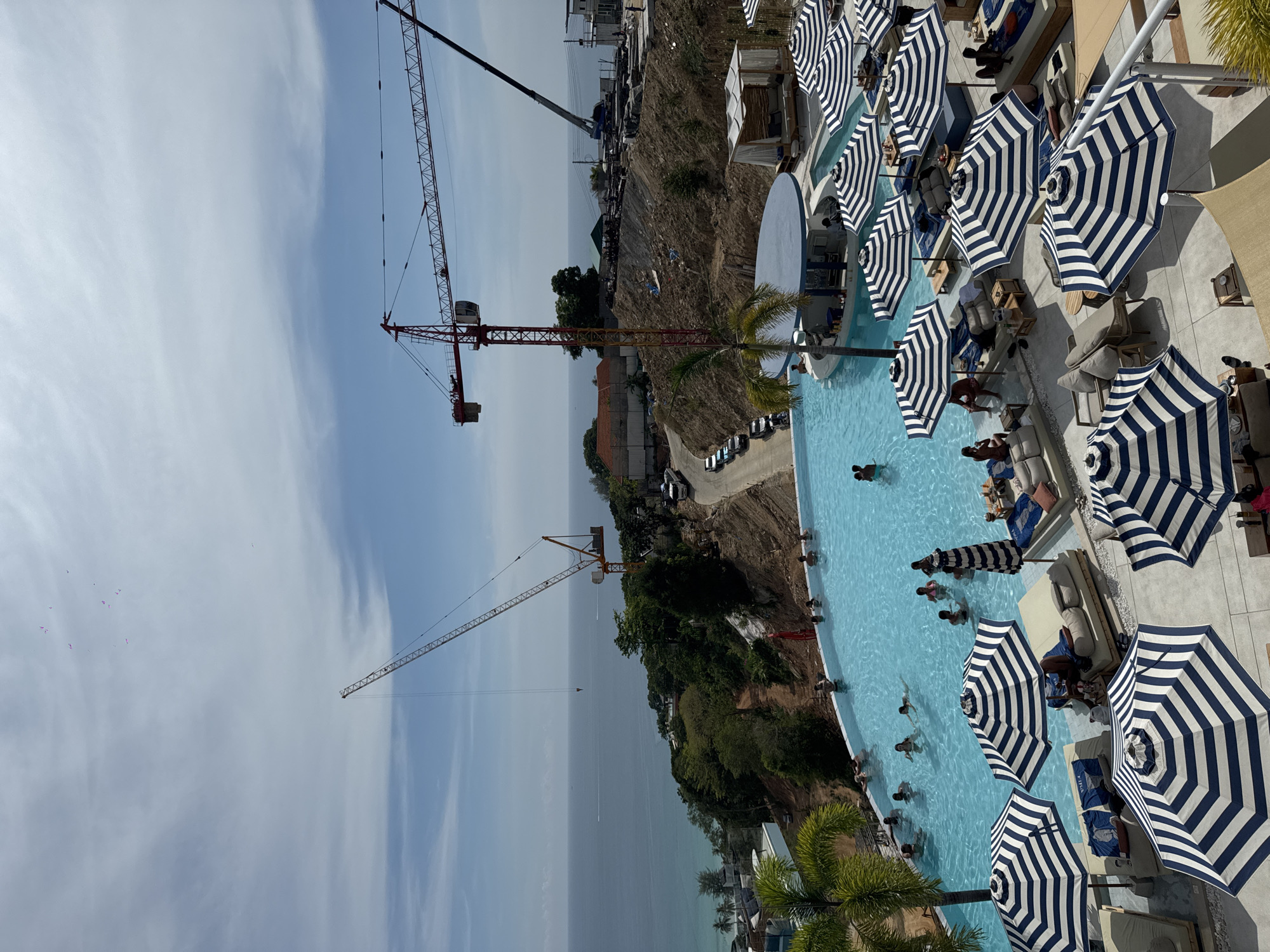 Beachside rooftop pool busy with swimmers in Karon Thailand